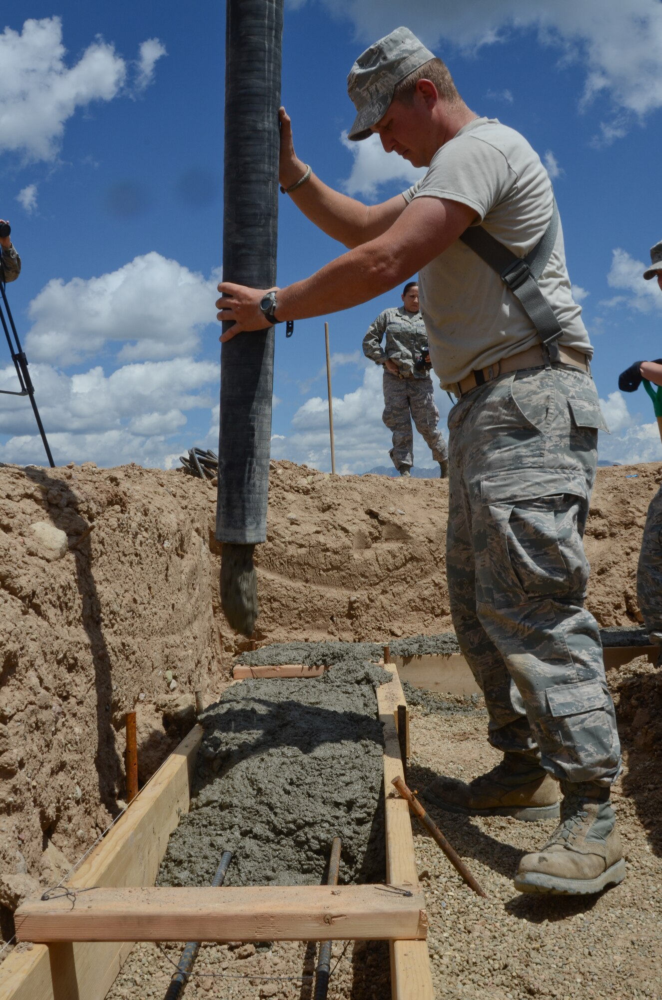 U.S. Air Force Master Sgt. Daniel Steidel with the Missouri Air National Guard, 139th Civil Engineering Squadron, pours concrete footings for the summer tubing hill kids consessions at Snow Mountain Ranch, near Winter Park, Colo., July 30, 2013.  The Airmen provided assistance with the construction and maintenance of various structures throughout the camp during an Innovative Readiness Training mission.   (U.S. Air National Guard photo by Senior Airman Patrick P. Evenson/Released)