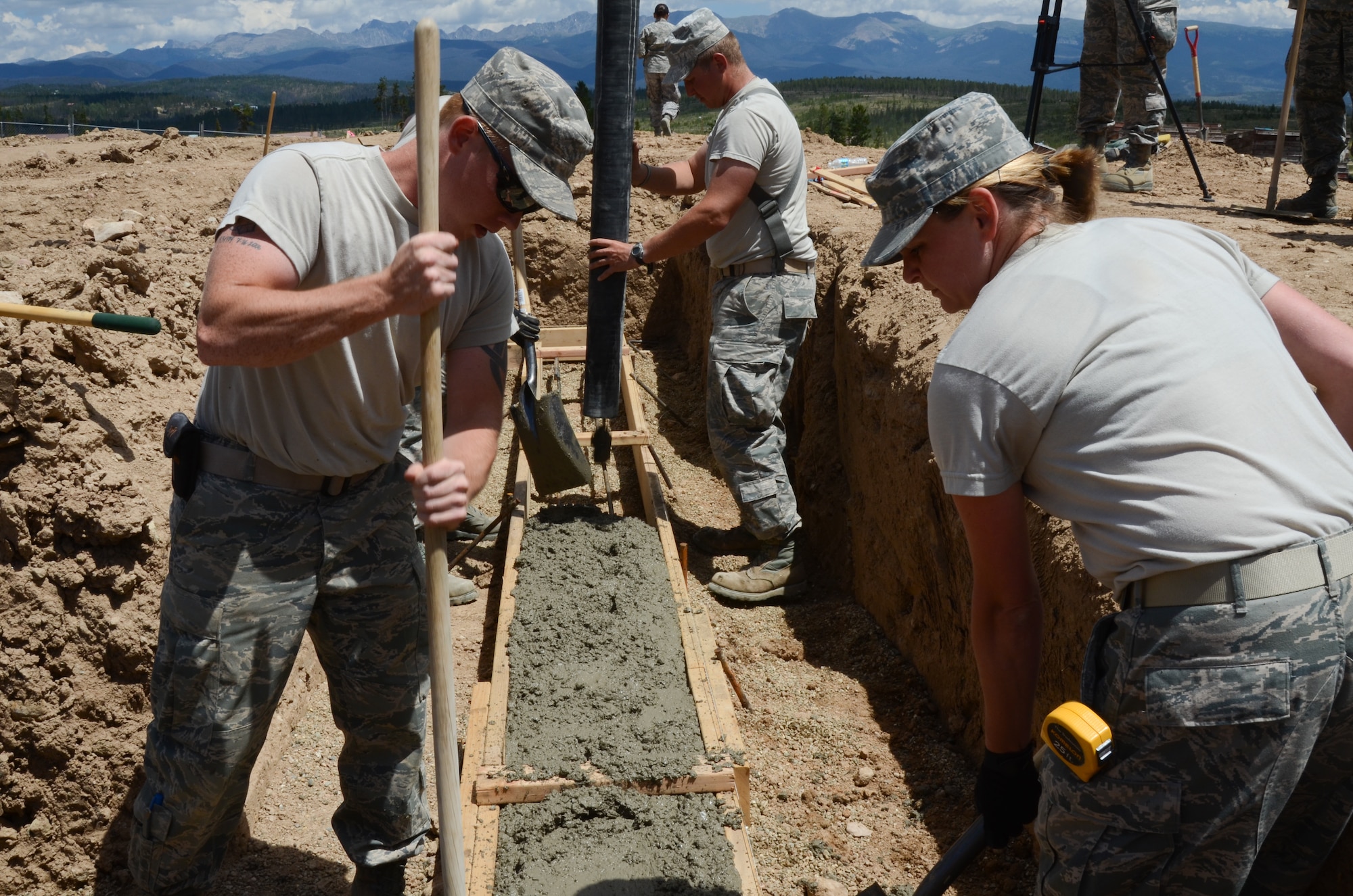 U.S. Air Force Airmen with the Missouri Air National Guard, 139th Civil Engineering Squadron, lays concrete footings for the summer tubing hill kids consessions at Snow Mountain Ranch, near Winter Park, Colo., July 30, 2013.  The Airmen provided assistance with the construction and maintenance of various structures throughout the camp during an Innovative Readiness Training mission.   (U.S. Air National Guard photo by Senior Airman Patrick P. Evenson/Released)