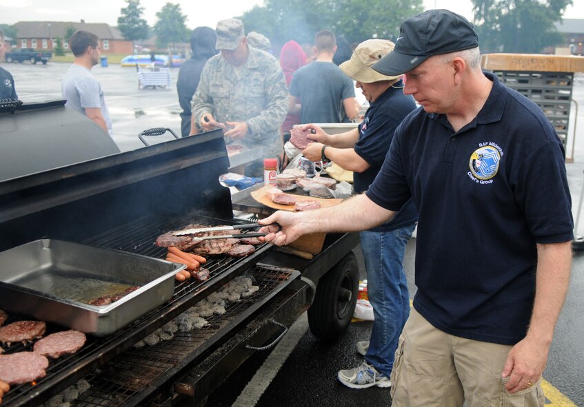 U.S. Air Force Chief Master Sgt. Daniel Trahan, 100th Security Forces Squadron enlisted manager, cooks hamburgers and hot dogs at the Unaccompanied Airmen Appreciation Day Aug. 2, 2013, on RAF Mildenhall. The event allowed Airmen serving at RAF Mildenhall without families to enjoy a day of leisure activities orchestrated specifically for them as a show of appreciation for their unique circumstances. (U.S. Air Force photo by Staff Sgt. Austin M. May/Released)