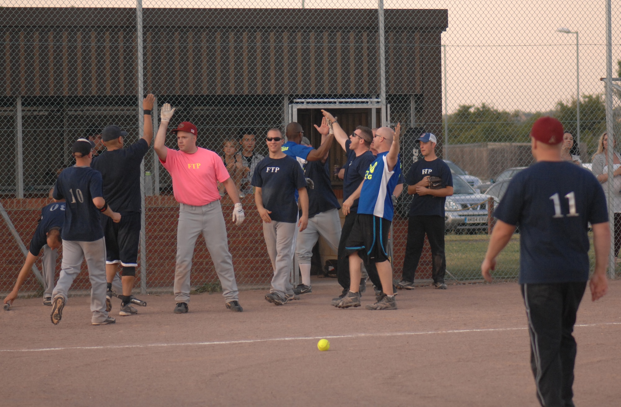 Members of the 100th Maintenance Group softball team celebrate after winning the intramural softball championship game against the 100th Operations Group Aug. 1, 2013, on RAF Mildenhall, England. To win the championship, the 100th MXG had to win two games in one night. (U.S. Air Force photo by Airman 1st Class Dillon Johnston/Released)
