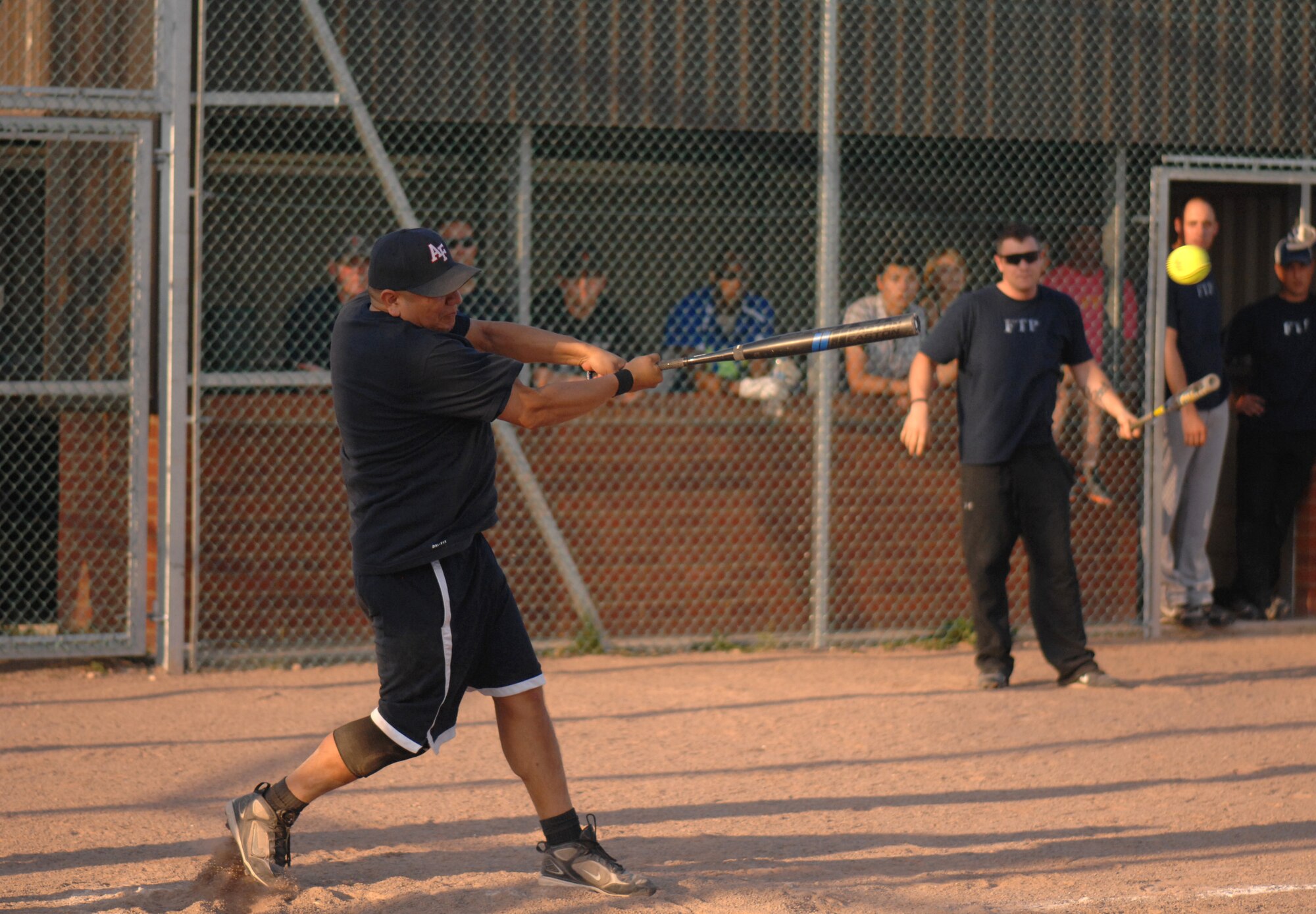 U.S. Air Force Tech. Sgt. George Ahboah, 100th Maintenance Group softball team member, hits the ball to bring in another run Aug. 1, 2013, during the intramural softball championship game between the 100th MXG and the 100th Operations Group on RAF Mildenhall, England. The 100th MXG ended the game by scoring 15 unanswered runs, securing the championship trophy. (U.S. Air Force photo by Airman 1st Class Dillon Johnston/Released)