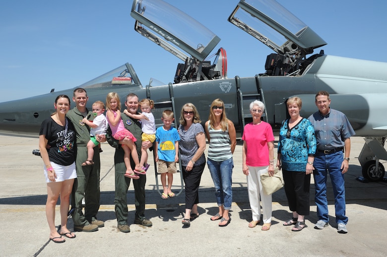 JOINT BASE SAN ANTONIO - RANDOLPH, Texas -- Lt. Gen. Douglas Owens, Air Education and Training Command vice commander, poses with his family after his last flight in a T-38 jet July 31, 2013, at Joint Base San Antonio-Randolph, Texas. Air Force pilots have a tradition where they are hosed down with water by their squadron comrades, friends and family upon the completion of their last flight. (U.S. Air Force photo/Rich McFadden)
