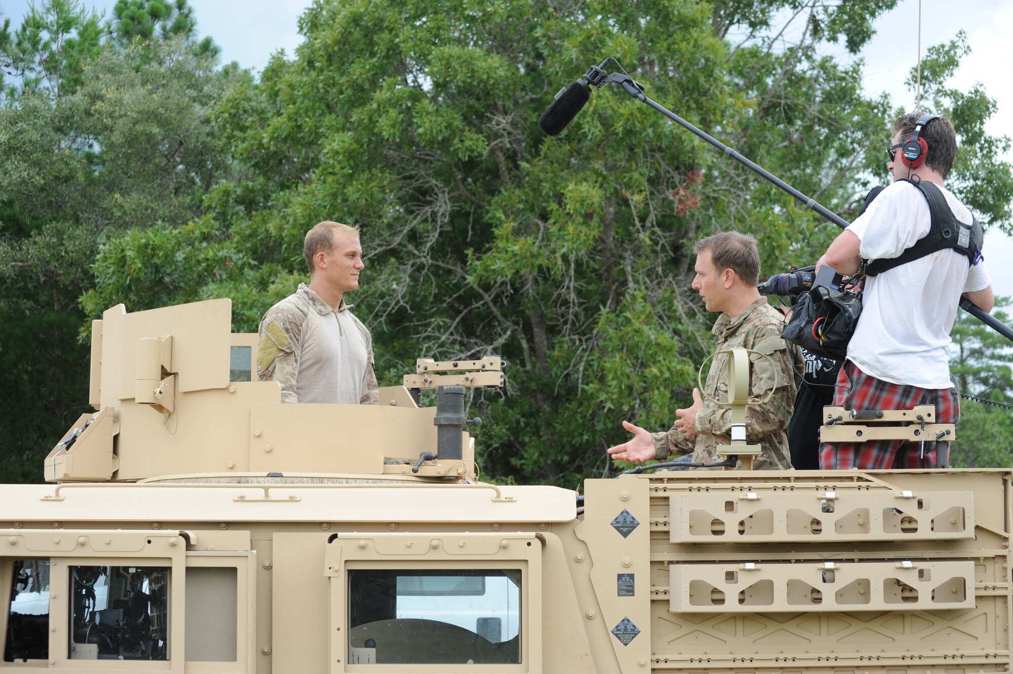 Mike Bettes, Weather Channel TV personality, right, interviews Senior Airman Jeffrey Gaiser, 10th Combat Weather Squadron, after a training exercise July 31, 2013 at the Eglin Range, Fla. The Weather Channel visited the unit while filming for an upcoming program. (U.S. Air Force photo by Capt. Victoria Porto)