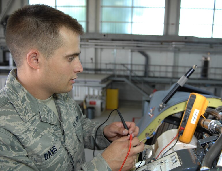 U.S. Air Force Senior Airman Randall Davis, 352nd Special Operations Maintenance Squadron CV-22 integrated avionics journeyman, tests wire voltages on a CV-22 August 1, 2013, on RAF Mildenhall, England. Davis was selected for the Square D Spotlight for portraying the Air Force core value of service before self. (U.S. Air Force photo by Airman 1st Class Dillon Johnston/Released)