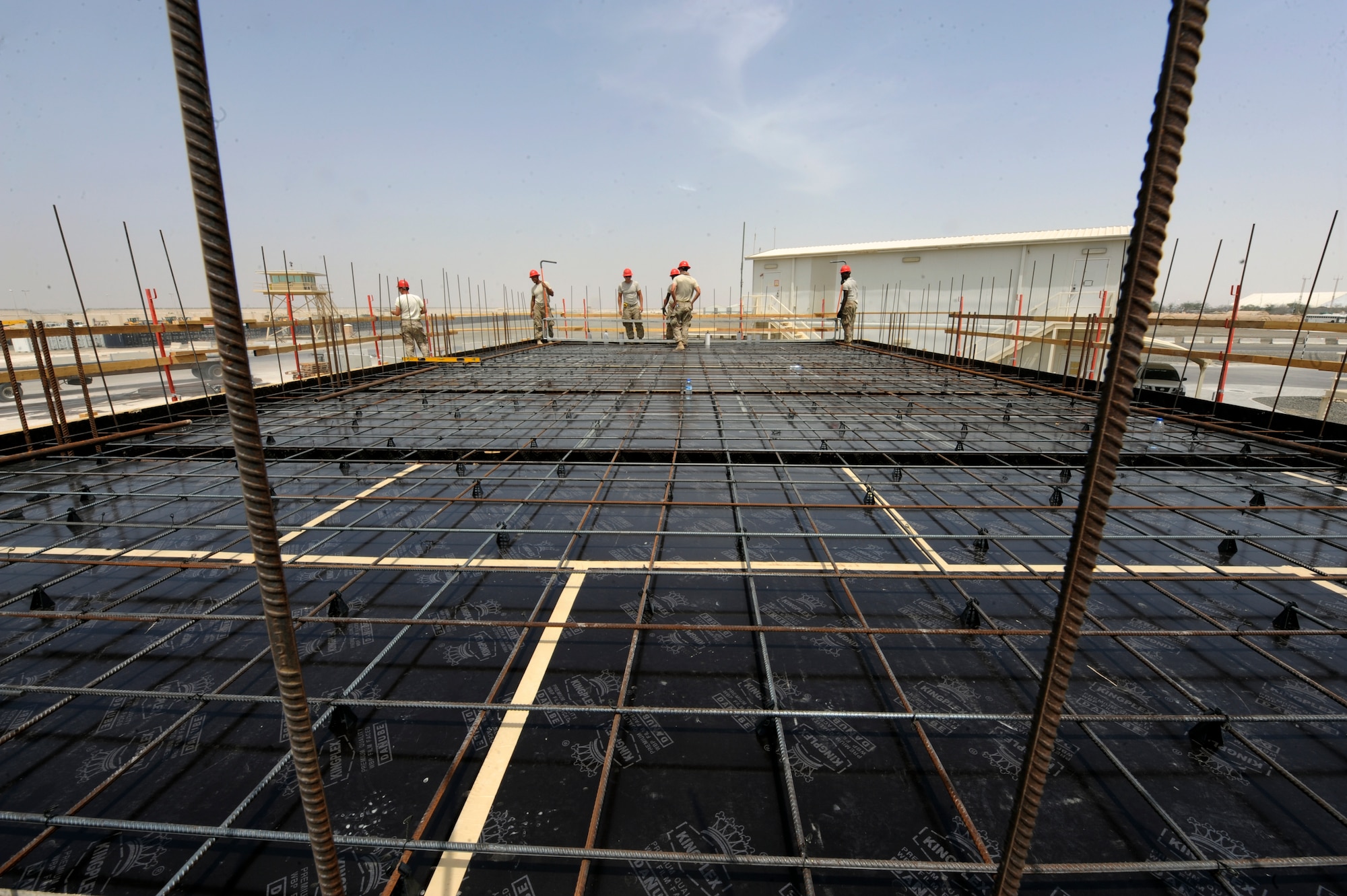 Airmen from the 577th Expeditionary RED HORSE Squadron prep the second floor of a building for a concrete pour at an undisclosed location in Southwest Asia July 31, 2013. The RED HORSE squadron has several projects the 380th Air Expeditionary Wing will benefit from once completed. The building will be used as an assembly area for pilot operations. (U.S. Air Force photo by Staff Sgt. Joshua J. Garcia)  