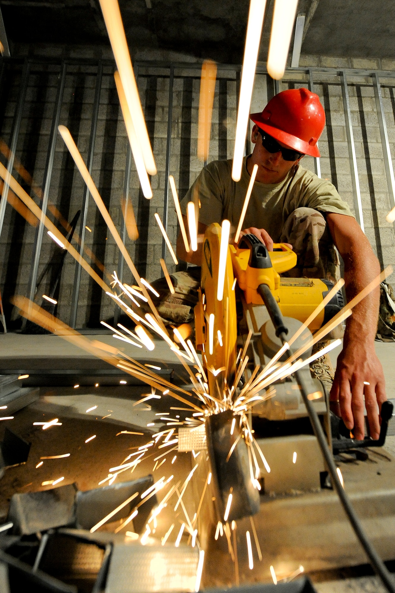 U.S. Air Force Staff Sgt. Eric MacDonald, 557tht Expeditionary RED HORSE Squadron structures journeyman, cuts wall frame beams to size at an undisclosed location in Southwest Asia July 31, 2013.  RED HORSE Airmen have the ability to go into a bare base and build from the ground up. MacDonald is from Great Falls, Mont., and is deployed from Malmstrom Air Force Base, Mont. (U.S. Air Force photo by Staff Sgt. Joshua J. Garcia) 