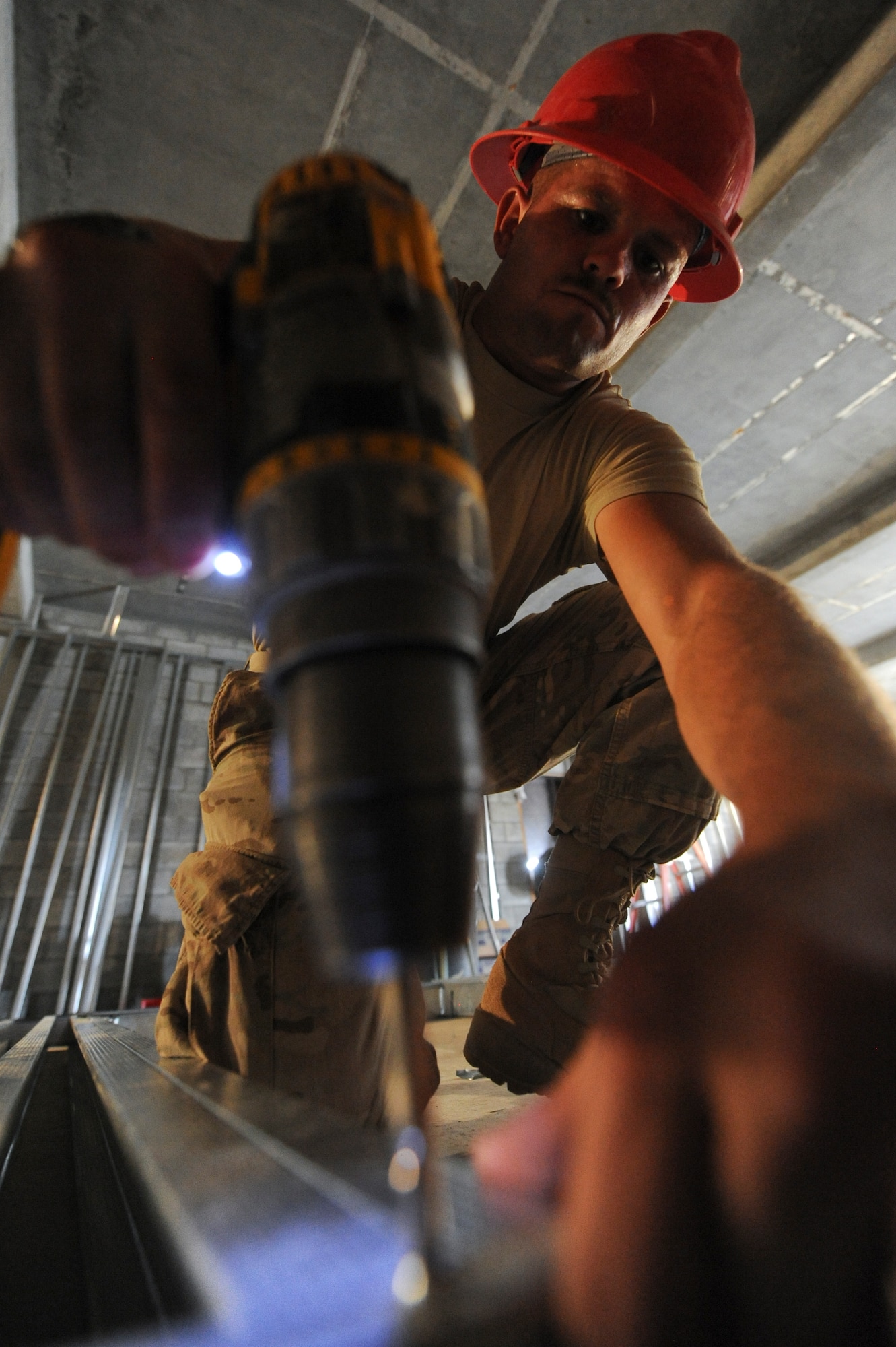 U.S. Air Force Senior Airman Robert Hansen, 557th Expeditionary RED HORSE Squadron structures journeyman, builds a wall frame at an undisclosed location in Southwest Asia July 31, 2013. Members of the RED HORSE squadron have the capability to forward deploy to another location if they are needed to finish a construction project. Hansen is native to Joseph City, Ariz., and is deployed from Malmstrom Air Force Base, Mont.  (U.S. Air Force photo by Staff Sgt. Joshua J. Garcia)