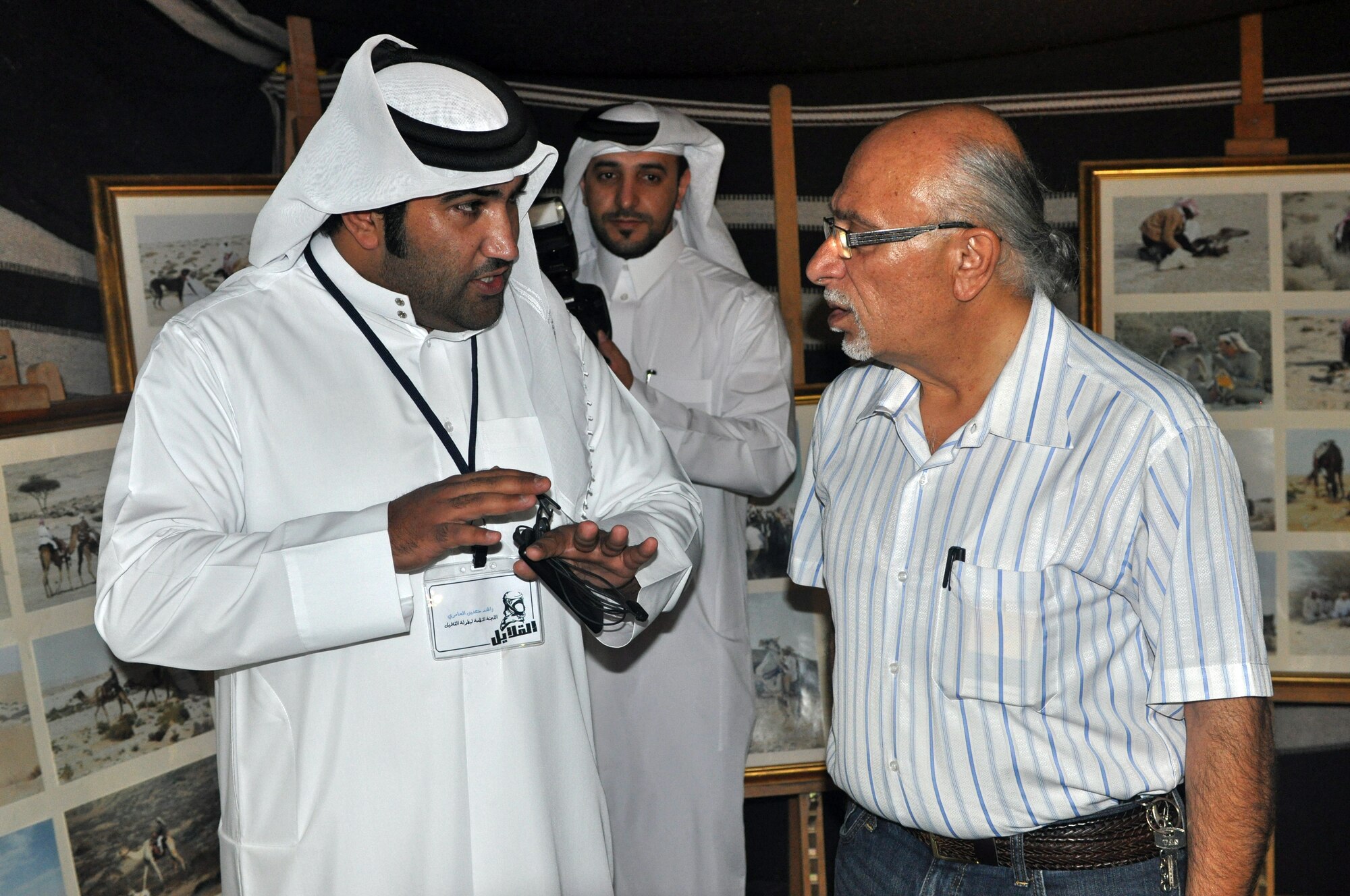 Raji Daboul discusses some traditions with a local during a “Khaymah Ramadaniyyah” or Ramadan tent celebration hosted by local government officials near the 379th Air expeditionary Wing in Southwest Asia, July 24, 2013. The tent celebration is a late evening gathering with snacks that follows the breaking of the fast dinner during the Muslim holy month of Ramadan. Daboul is a host nation cultural advisor with the 379th AEW Host Nation Coordination Cell. (U.S. Air Force photo/1st Lt. Susan Harrington) 