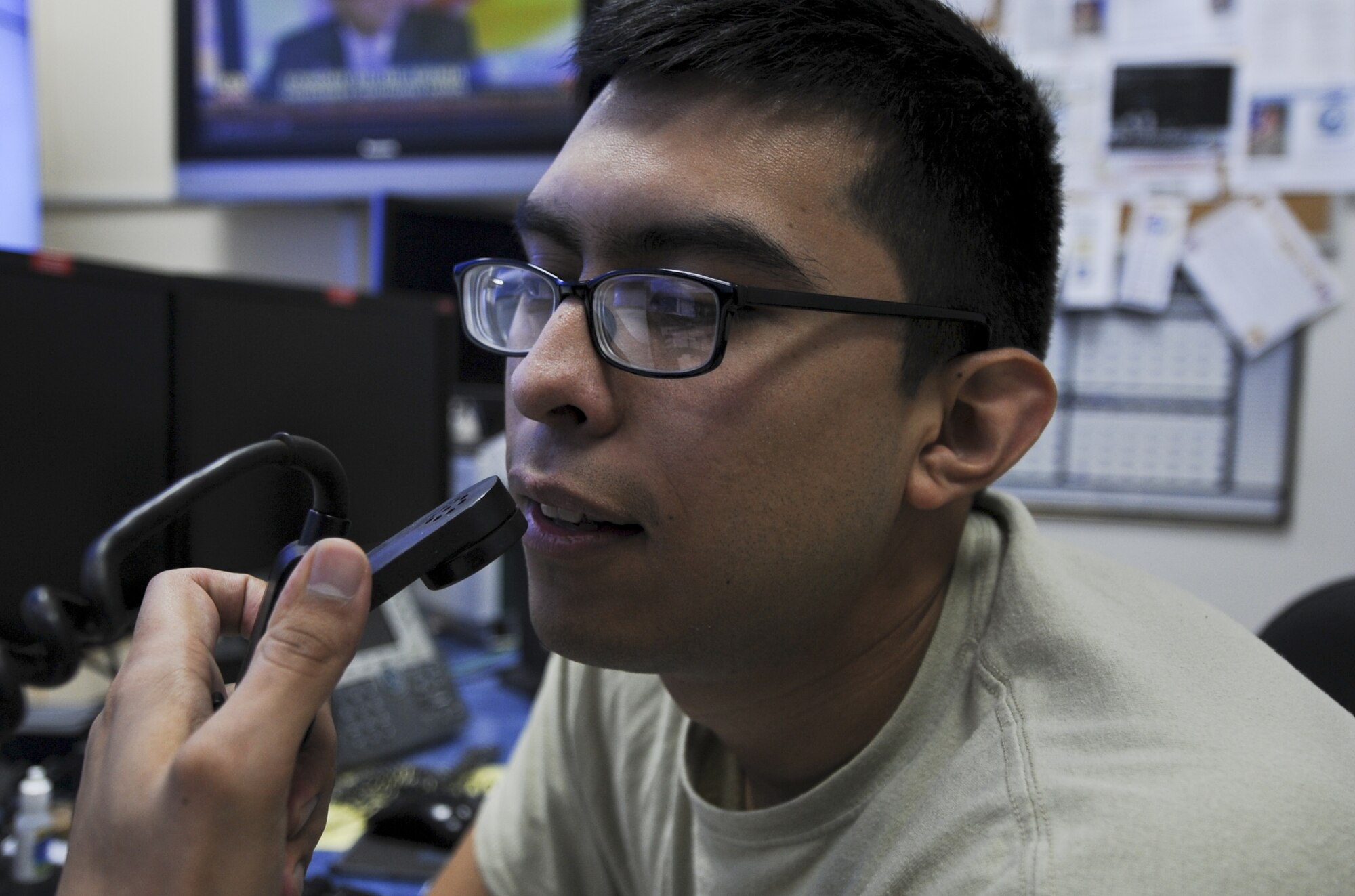 U.S. Air Force Airman 1st Class Steven Estrada, 380th Air Expeditionary Wing Command Post controller, speaks on the radio while doing an operational radio check with various base emergency agencies at an undisclosed location in Southwest Asia July 30, 2013. The command post keeps the base connected and informed through myriad communications tools. Estrada calls Tucson, Arizona home and is deployed from Sheppard Air Force Base, Texas. (U.S. Air Force photo by Staff Sgt. Jacob Morgan)