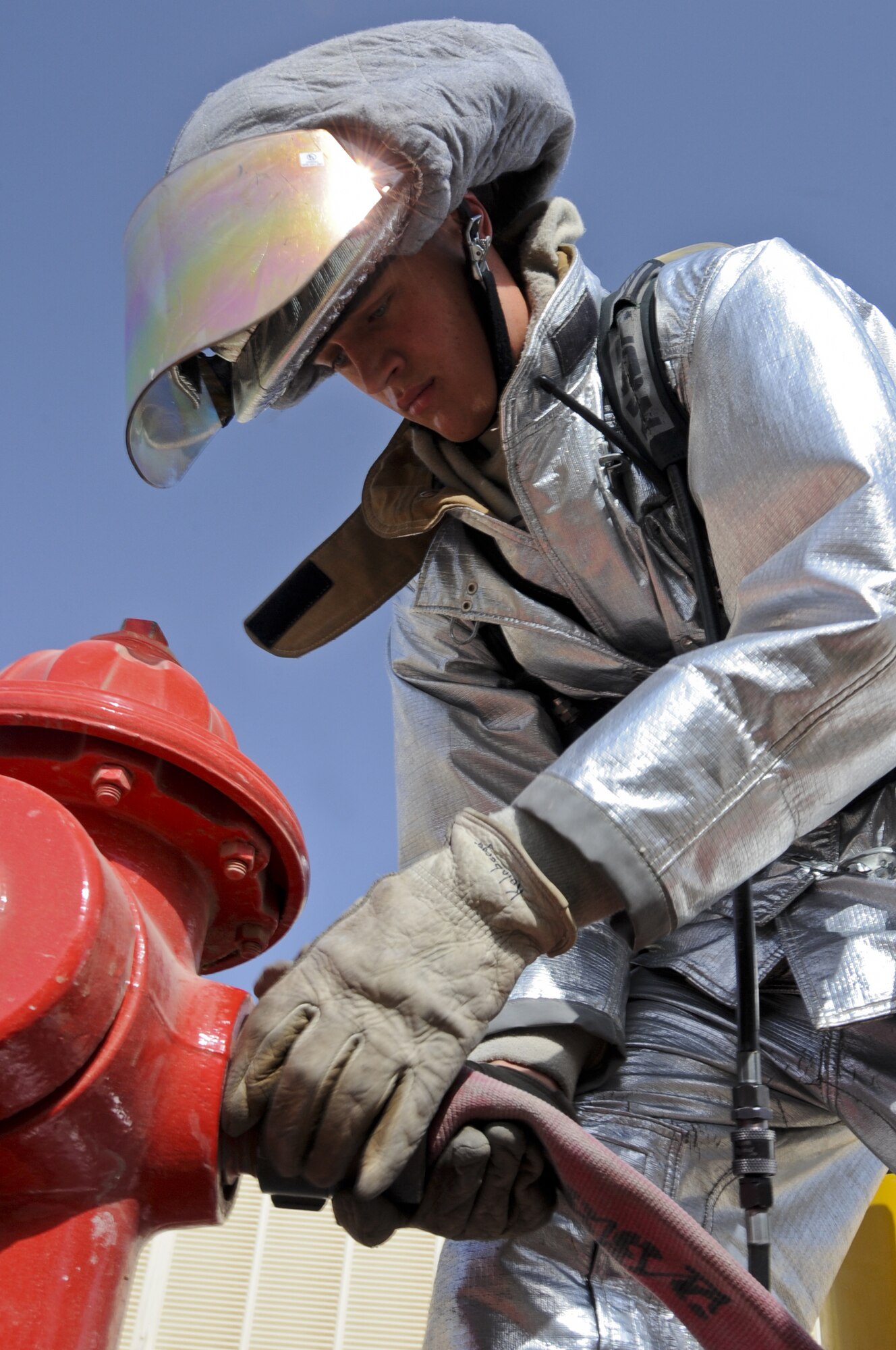 U.S. Air Force Airman 1st Class Alex Kolnberger, 380th Civil Engineer Squadron Fire Department handlineman, connects a hose to a fire hydrant at an undisclosed location in Southwest Asia Aug. 1, 2013. During an exercise, Kolnberger’s team was required to show the capability to swiftly deploy handline hoses. Kolnberger calls South St. Paul, Minn., home and is deployed from Eielson Air Force Base, Alaska. (U.S. Air Force photo by Staff Sgt. Jacob Morgan)