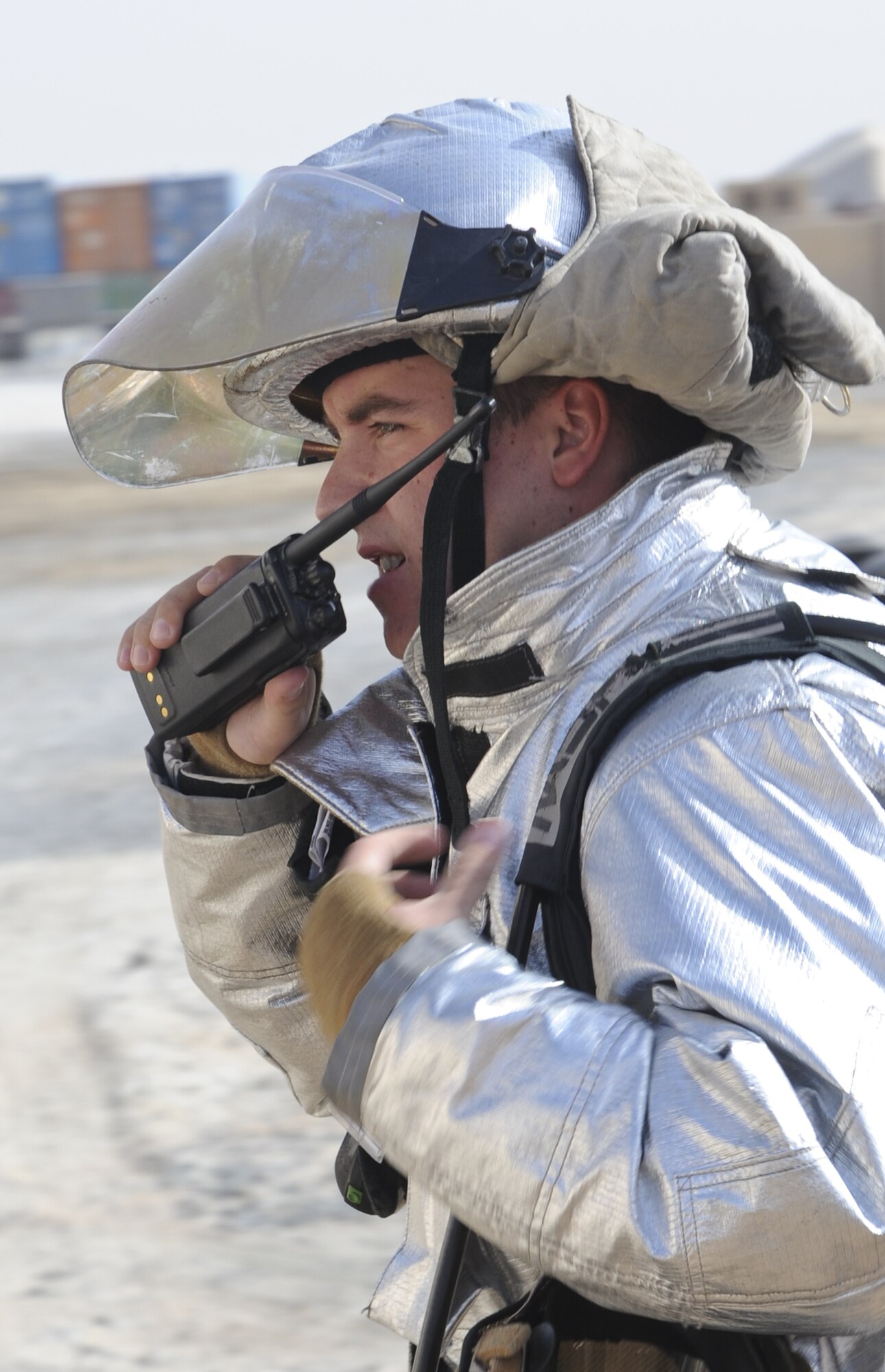 U.S. Air Force Staff Sgt. Aaron Danielson, 380th Civil Engineer Squadron Fire Department crew chief, radios the building manager of a CES warehouse to try and pin point the location of a simulated fire at an undisclosed location in Southwest Asia Aug. 1, 2013. Firefighters are often faced with being able to make decisions on the spot in the face of danger. Danielson calls Andover, N.J., home and is deployed from Joint Base McGuire-Dix-Lakehurst, N.J. (U.S. Air Force photo by Staff Sgt. Jacob Morgan)