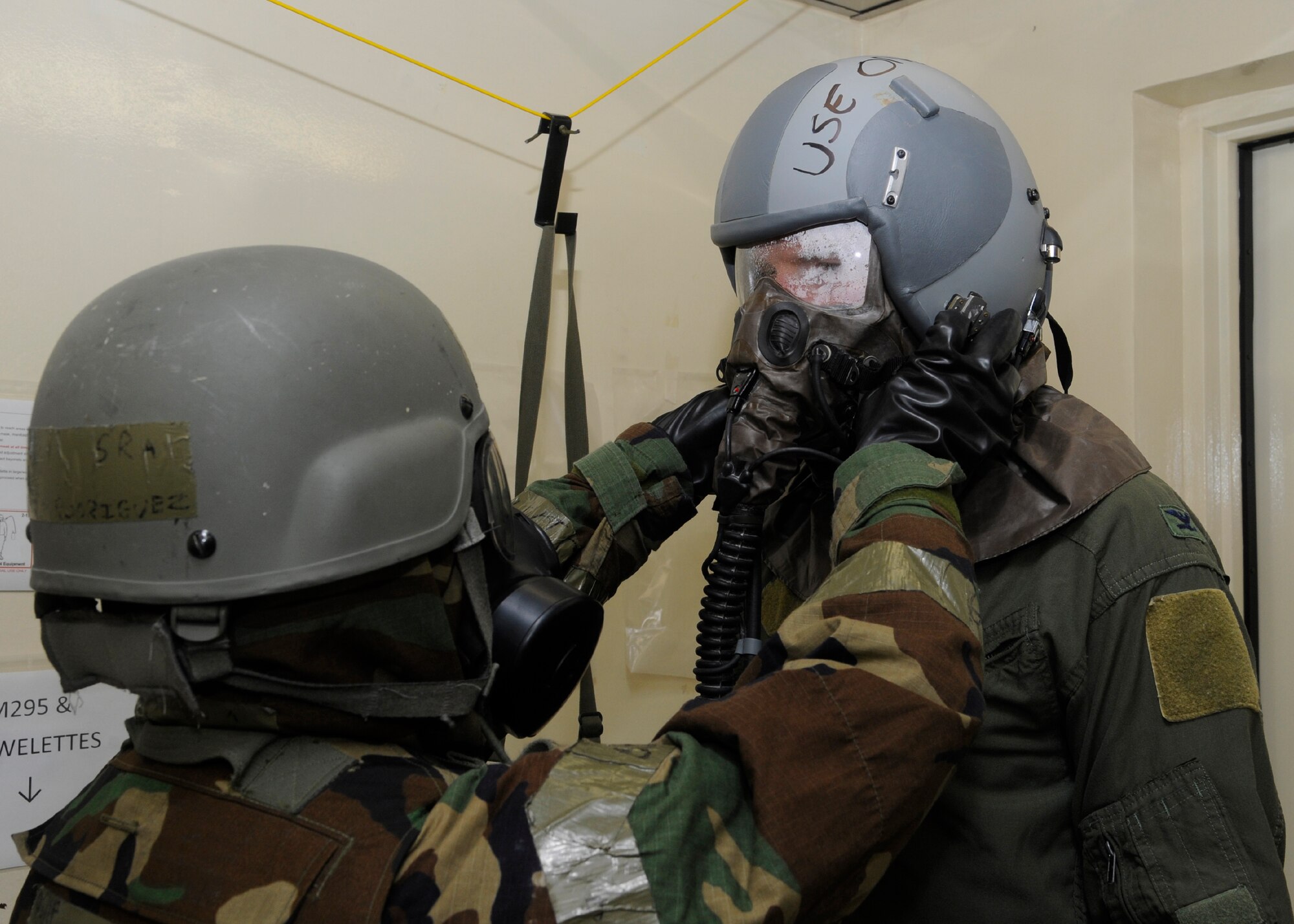 Senior Airman David Rodriguez, 8th Operations Support Squadron aircrew flight equipment technician, helps Col. S. Clinton Hinote, 8th Fighter Wing commander, through the aircrew decontamination station during a training session at Kunsan Air Base, Republic of Korea, July 27, 2013. AFE has been preparing for the upcoming exercise since April. (U.S. Air Force photo by Staff Sgt. Jessica Haas/Released)