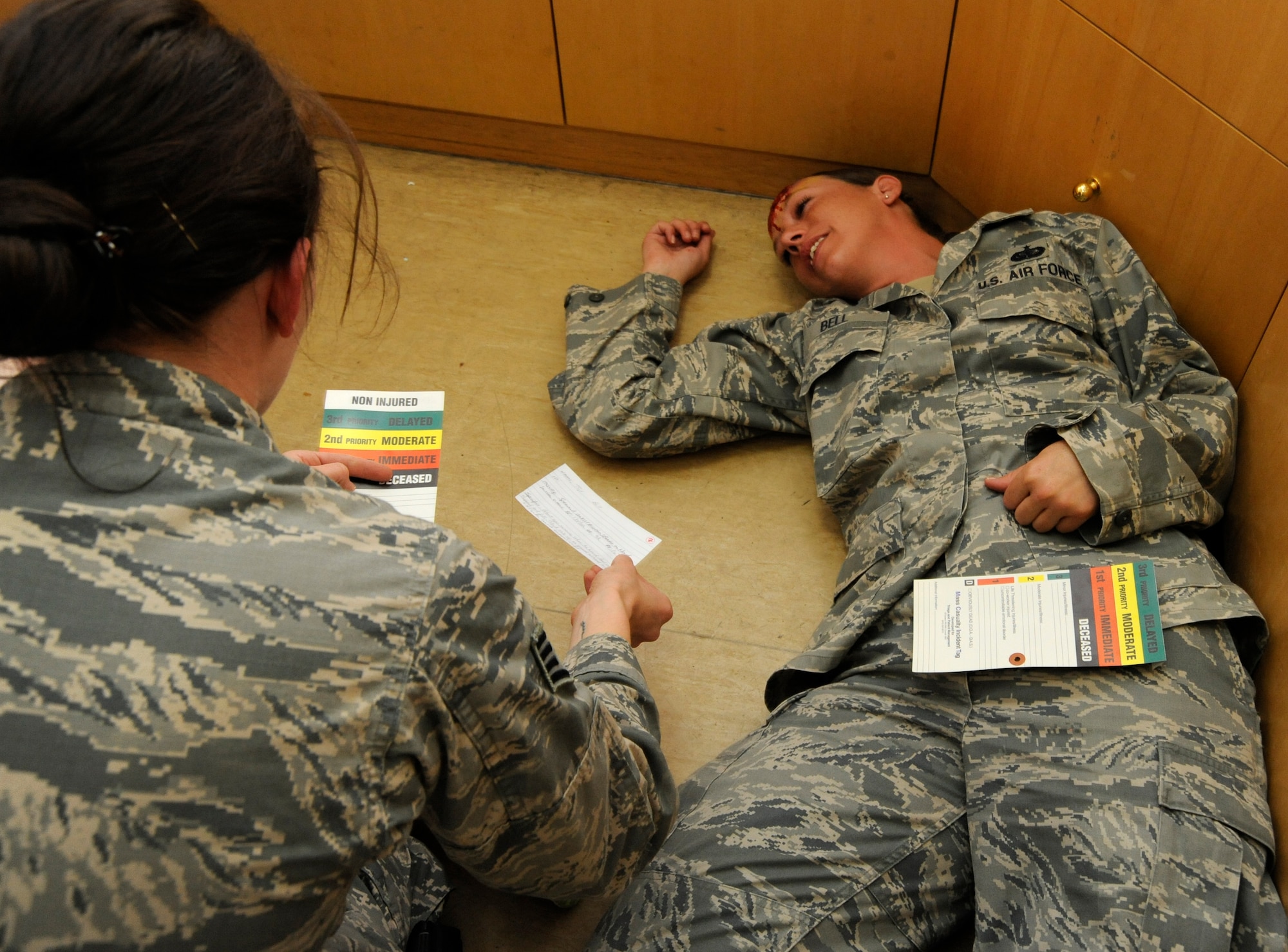 Staff Sgt. Kaylen Hoeppner triages Tech. Sgt. Ginger Bell’s injuries to determine the priority of treatment during a 379th Expeditionary Medical Group mass casualty exercise at the 379th Air Expeditionary Wing in Southwest Asia, July 26, 2013. Hoeppner is a 379th Expeditionary Medical Operations Squadron aerospace medical technician deployed from Joint Base Langley-Eustis, Va., and Bell is a 379th Expeditionary Force Support Squadron contracting officer representative deployed from Travis Air Force Base, Calif. (U.S. Air Force photo/Senior Airman Bahja J. Jones) 