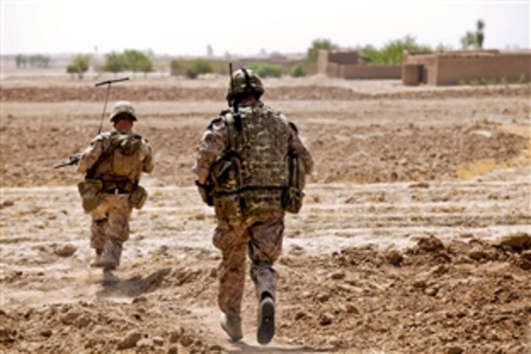 U.S. Marine Corps Sgt. Joshua Farrell, left, and British Lance Cpl. Thomas Bailey move toward the enemy after taking fire during Operation Grizzly in Helmand province, Afghanistan, July 18, 2013. Farrell and Bailey, a member of the British air force, are assigned to Fox Company, 2nd Battalion, 2nd Marine Regiment. 