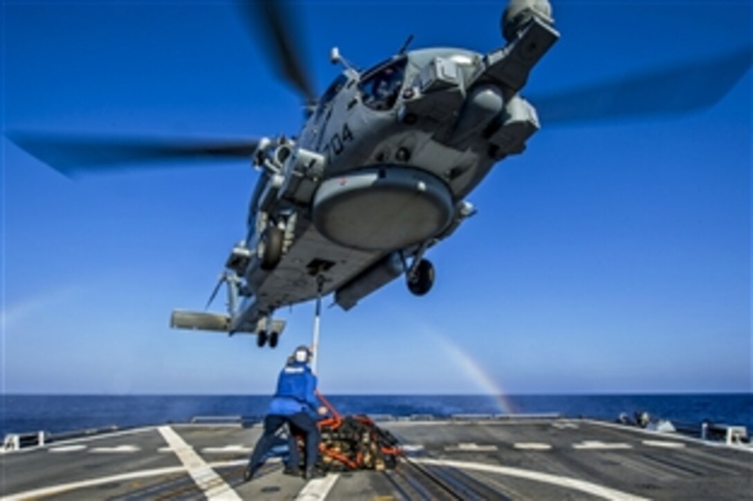 U.S. sailors hook cargo to an MH-60R Seahawk helicopter during vertical replenishment training aboard the guided-missile destroyer USS Gravely in the Mediterranean Sea, July 31, 2013. The Gravely is supporting maritime security operations and theater security cooperation efforts in the U.S. 6th Fleet area of responsibility. The Seahawk is assigned to Helicopter Maritime Strike Squadron 74.