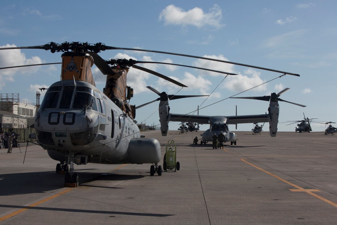 An MV-22B Osprey taxis behind a CH-46E Sea Knight Helicopter after its arrival at Marine Corps Air Station Futenma Aug. 3. Two Osprey aircraft, part of the second Osprey squadron to Japan, flew from MCAS Iwakuni. The arrival of the second Osprey squadron will complete the one-for-one replacement of the older CH-46E Sea Knight helicopters on Okinawa. The Osprey can fly twice as fast, carry three times the payload, and fly four times the distance of the older CH-46E. Its capabilities significantly benefit the U.S.-Japan alliance and strengthen III Marine Expeditionary Force’s ability to provide for the defense of Japan and perform humanitarian assistance and disaster response missions. The aircraft are part of Marine Medium Helicopter Squadron 262, Marine Aircraft Group 36, 1st Marine Aircraft Wing, III MEF. (U.S. Marine Corps photo by Cpl. Matthew J. Manning/Released)
