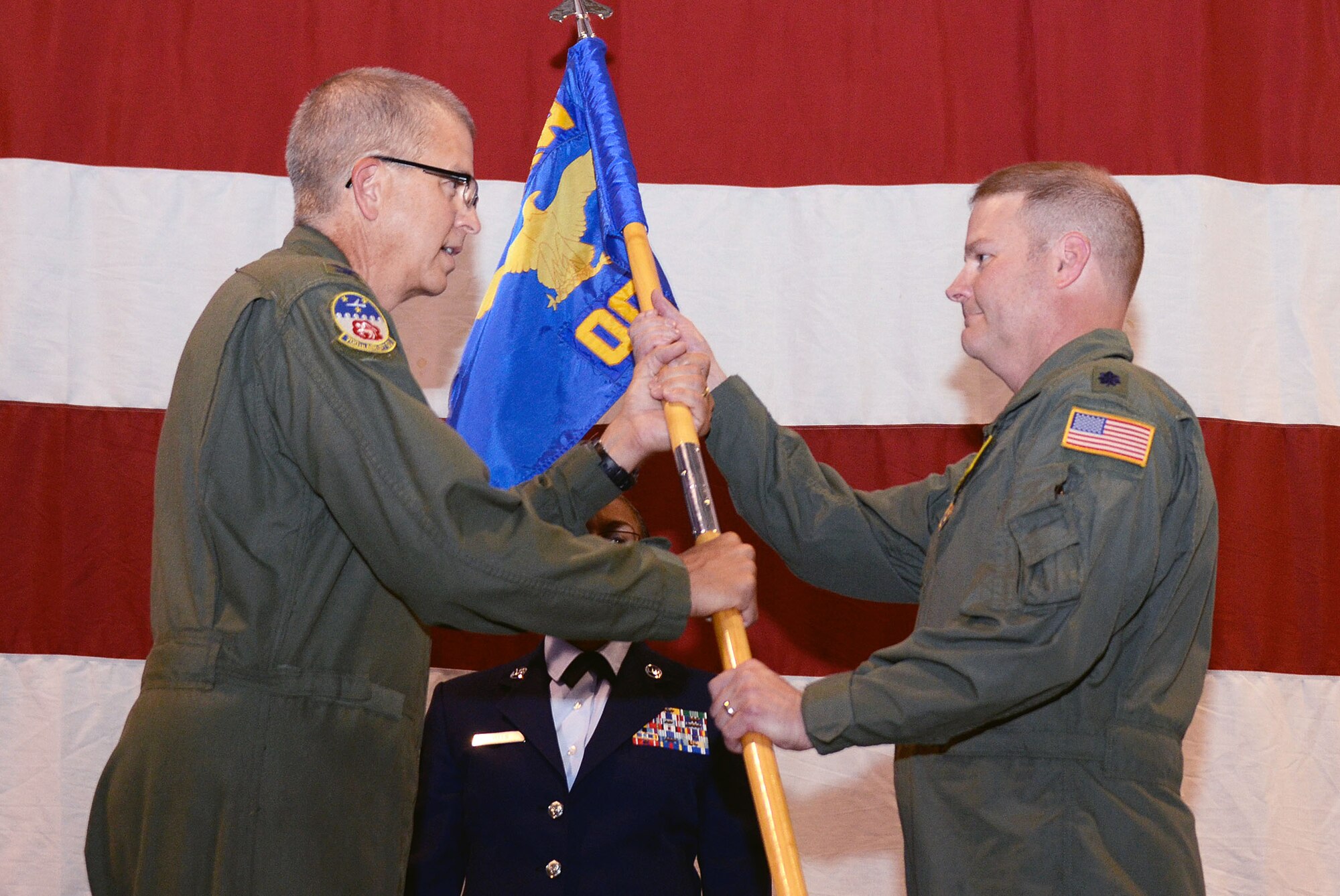 Lt. Col. James R. DeVere receives the unit guidon from Col. Tim E. Tarchick, 94th Airlift Wing commander, as he assumes command of the 94th Operations Group, Dobbins Air Reserve Base, Ga., during an assumption of command ceremony Aug 3. (U.S. Air Force photo/Don Peek)