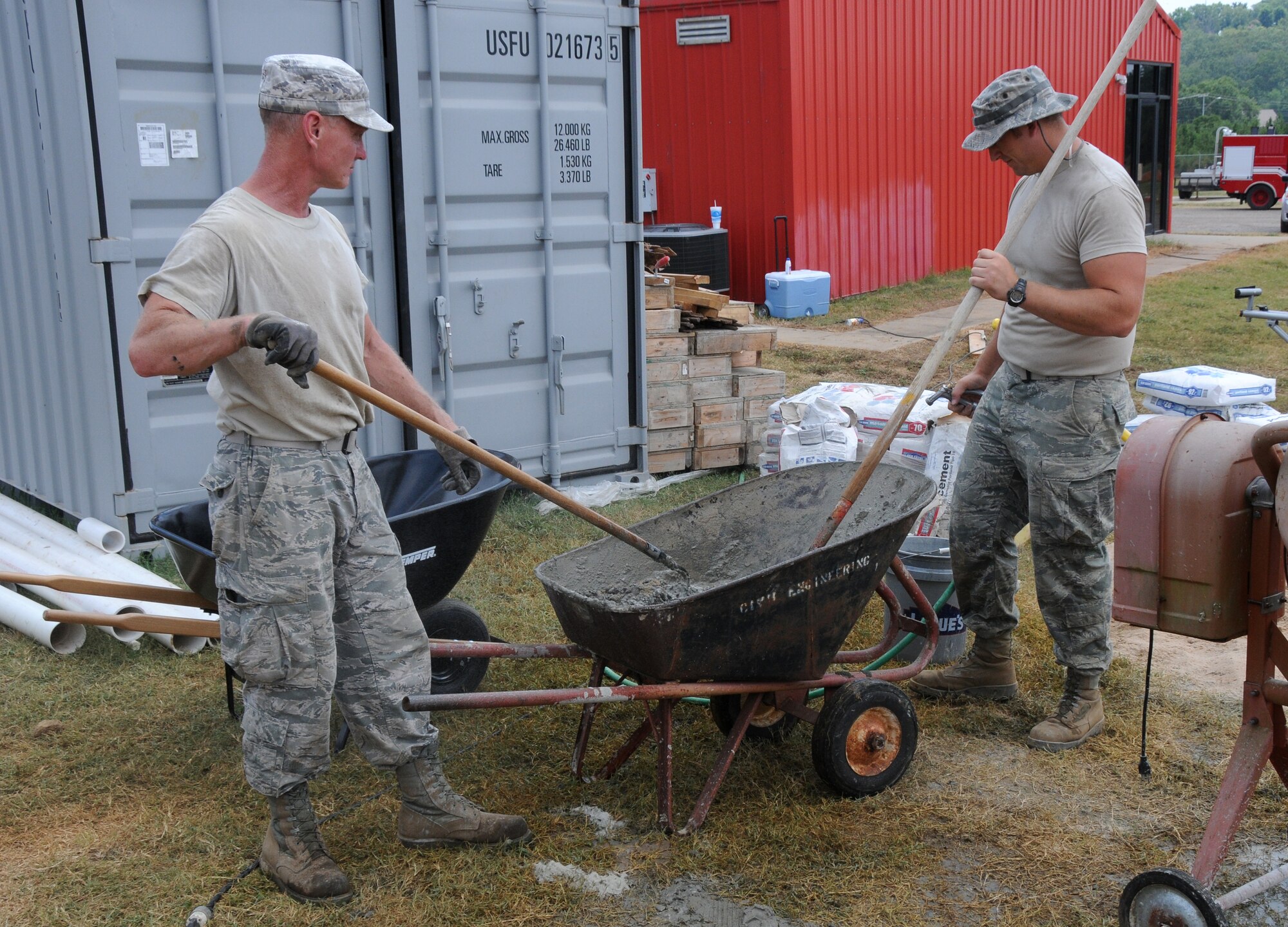 188th Civil Engineering Squadron Airmen mix cement at the 188th's urban search and rescue training site, July 15, 2013. CES Airmen are expanding capacity at the facility, which trains Guardsmen from across the country in rescue techniques. (U.S. Air National Guard photo by Senior Airman John Hillier/188th Fighter Wing Public Affairs)
