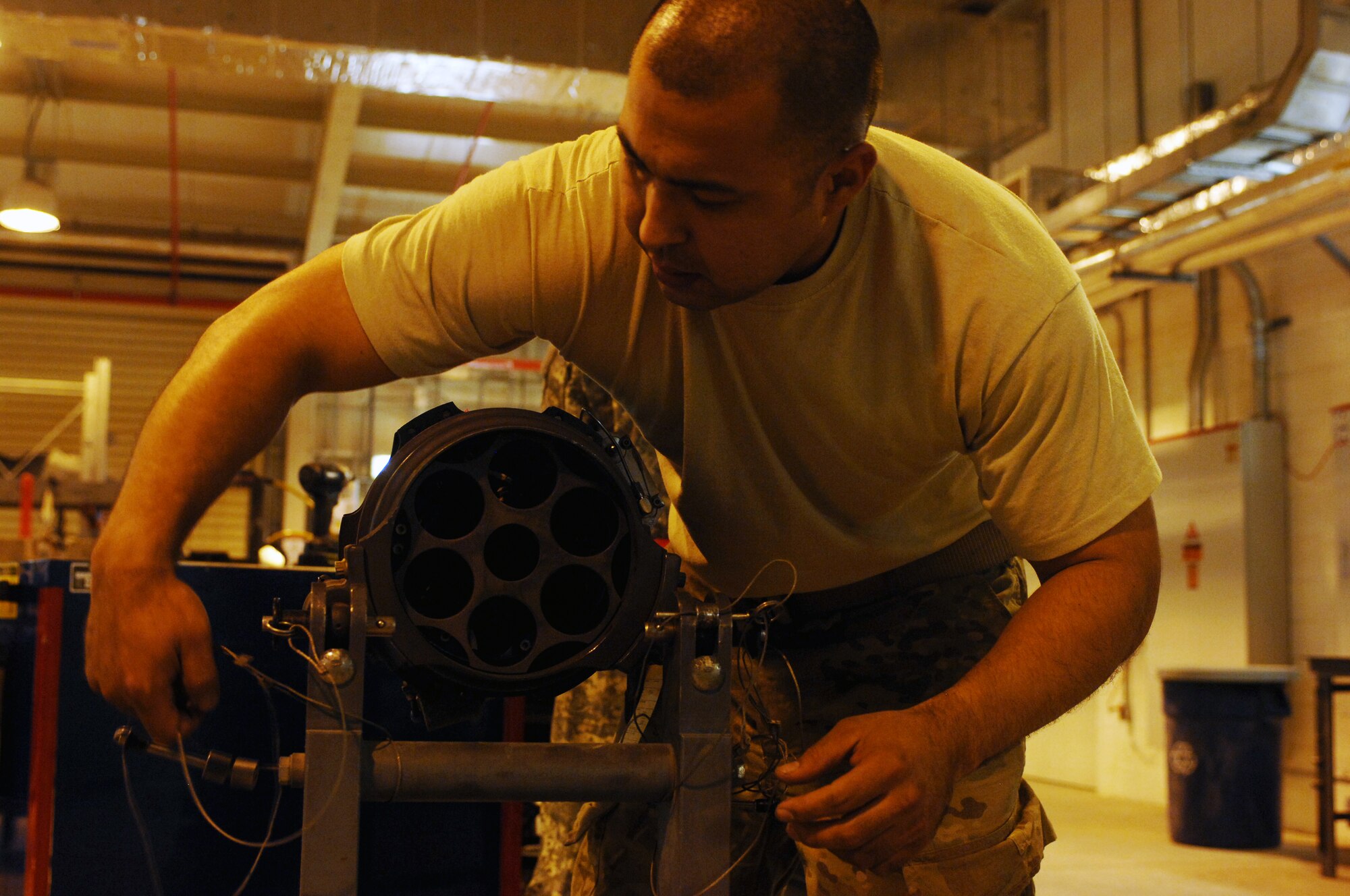 Staff Sgt. Eduardo Sera, 451st Expeditionary Maintenance Squadron armament back shop floor chief, prepares part of an F-16 Fighting Falcon weapons system for disassembly and cleaning at Kandahar Airfield, Afghanistan, July 25, 2013. Regular maintenance on aircraft weapons systems enables the wing to meet the air tasking order and provide close air support to NATO forces. Sera is stationed at Spangdahlem Air Base, Germany. (U.S. Air Force photo by Senior Airman Jack Sanders)