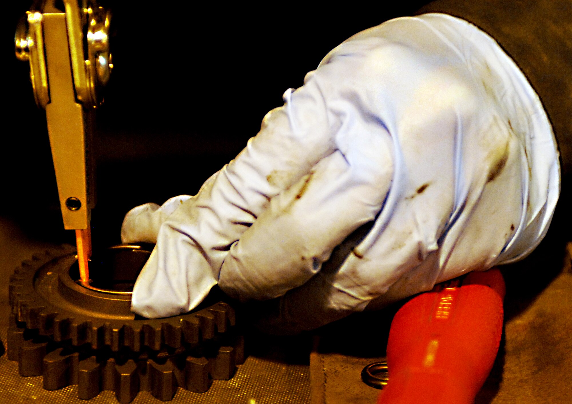 Senior Airman Jerin Krystle, 451st Expeditionary Maintenance Squadron armament back shop combat technician, carefully installs a small part on an entrance unit for an F-16 Fighting Falcon weapons system at Kandahar Airfield, Afghanistan, July 25, 2013. Keeping aircraft flying requires a whole host of maintainers working on the flightline and in the back shops. Krystle is stationed at Spangdahlem Air Base, Germany, and a native of Sumner, Iowa. (U.S. Air Force photo by Senior Airman Jack Sanders)