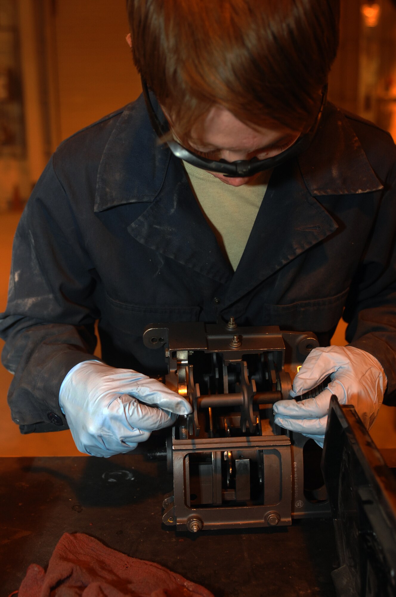 Senior Airman Jerin Krystle, 451st Expeditionary Maintenance Squadron armament back shop combat technician, inspects part of an entrance unit for an F-16 Fighting Falcon weapons system at Kandahar Airfield, Afghanistan, July 25, 2013. Regular maintenance on aircraft weapons systems enables the wing to meet the air tasking order and provide close air support to NATO forces. Krystle is stationed at Spangdahlem Air Base, Germany, and is a native of Sumner, Iowa. (U.S. Air Force photo by Senior Airman Jack Sanders)