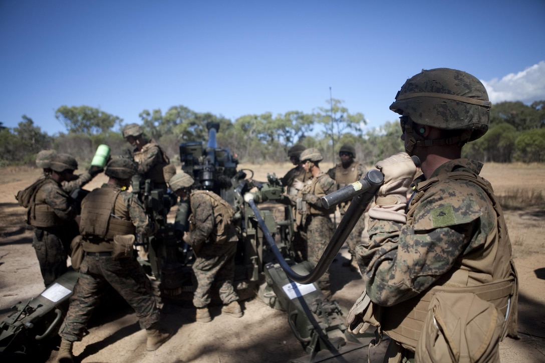 Artillerymen with Echo Battery, 2nd Battalion, 4th Marines, 31st Marine Expeditionary Unit, load a high explosive round in support of a combined artillery and close air support training exercise following the conclusion of Talisman Saber 2013 here, Aug. 1.  The live-fire exercise provided effective and intense training to ensure Australian and U.S. forces are capable, interoperable, deployable on short notice and combat-ready. The 31st MEU is the Marine Corps’ force in readiness for the Asia-Pacific region and the only continuously forward-deployed MEU.