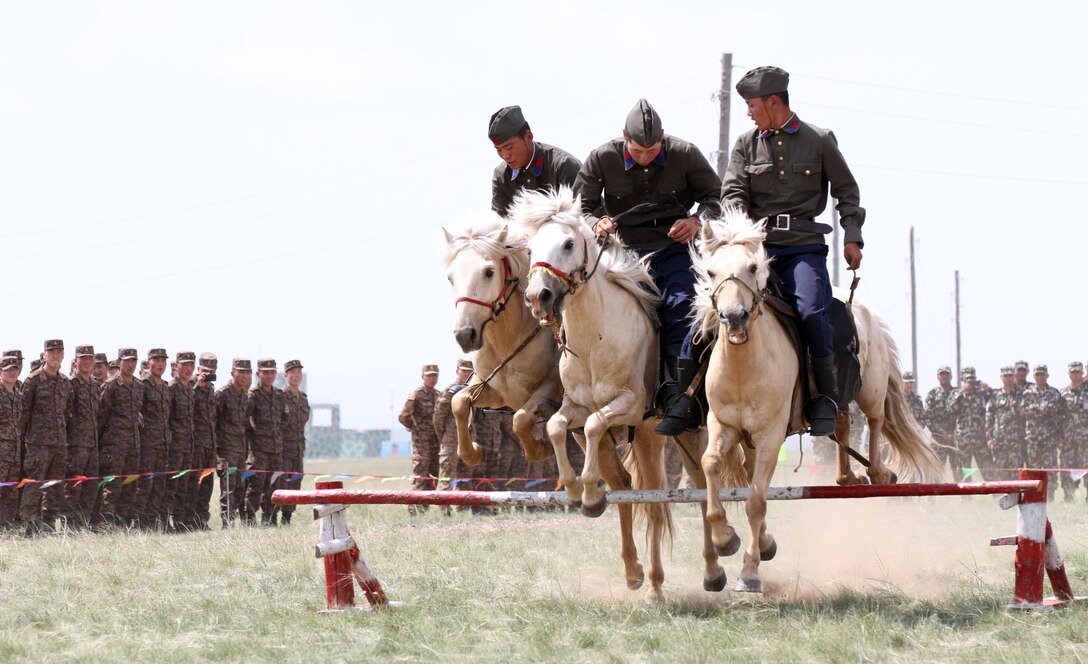 Members of the Mongolian Armed Forces 234 Calvary Unit, give a demonstration of thier riding skills during the opening ceremony of Exercise Khaan Quest in Five Hills Training Area, Mongolia, August 2, 2013. Khaan Quest is an annual multinational exercise sponsored by the U.S. and Mongolia, and it is designed to strengthen the capabilities of U.S., Mongolian and other nations’ forces in international peace support operations.