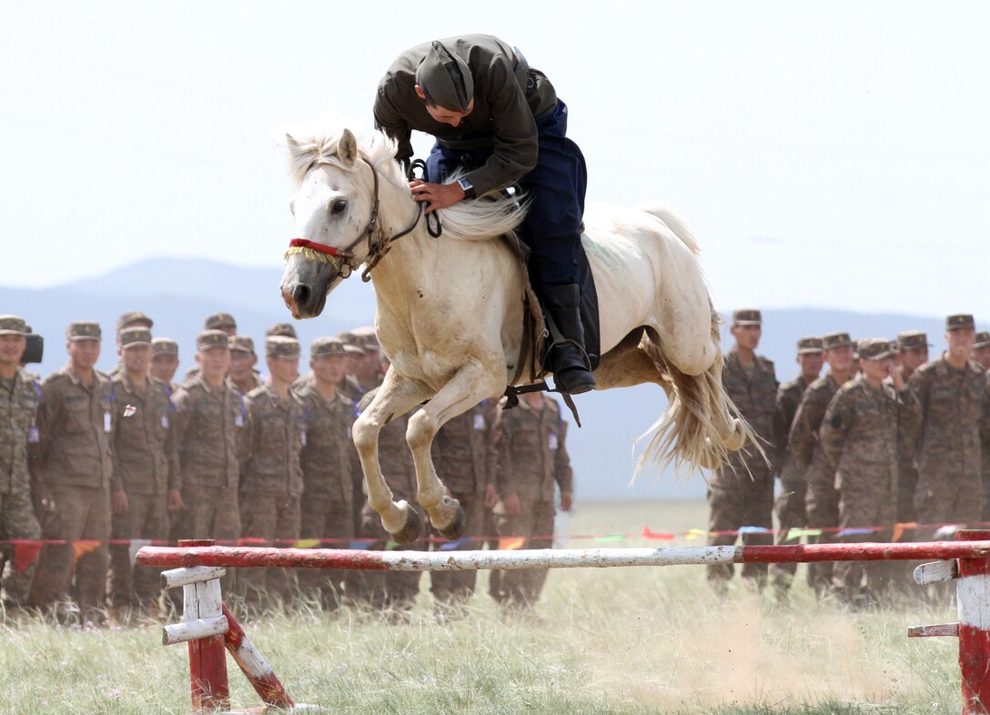 A Member of the Mongolian Armed Forces 234 Calvary Unit, jumps his horse during the opening ceremony of Exercise Khaan Quest in Five Hills Training Area, Mongolia, August 2, 2013. Khaan Quest is an annual multinational exercise sponsored by the U.S. and Mongolia, and it is designed to strengthen the capabilities of U.S., Mongolian and other nations’ forces in international peace support operations.
