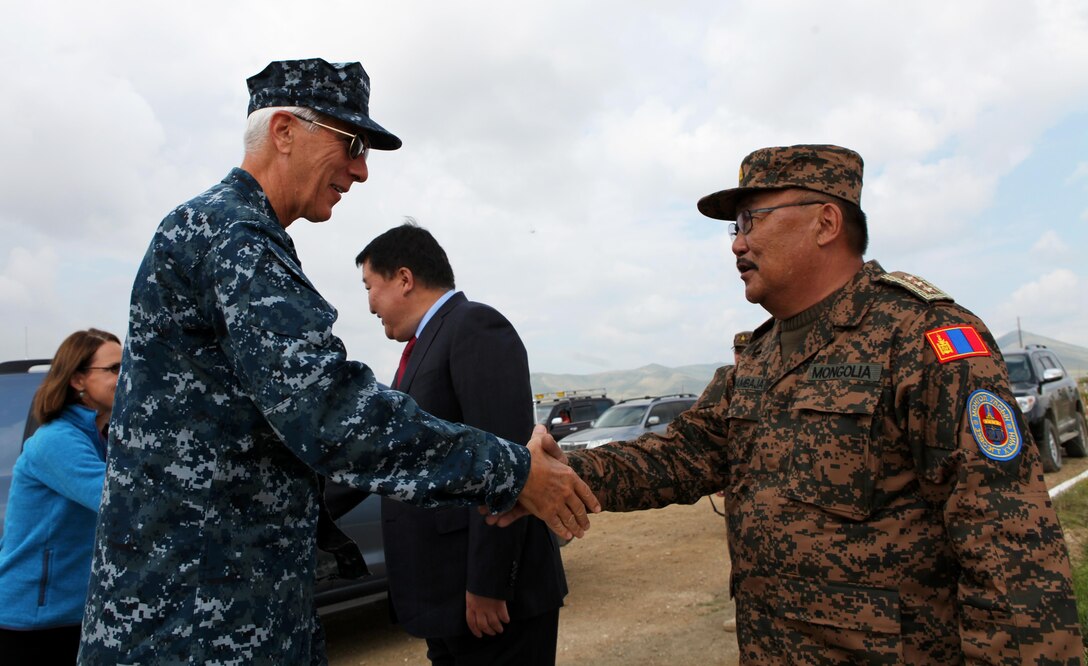Lt. Gen. Ts. Byambajav (right), Chief of General Staff, Mongolian Armed Forces, greets Adm. Samuel Locklear, commander of U.S. Pacific Command, at Five Hills Training Area prior to the Khaan Quest 2013 opening ceremony, Aug 3. Approximately 1,000 service members from 13 different nations are participating in Khaan Quest 2013, which consists of a command post exercise (CPX) and field training exercise (FTX) at Five Hills Training Area, both focusing on peacekeeping and stability operations. Mongolian and U.S. armed forces, along with other regional partners, will also participate in Engineering Civic Action Program (ENCAP) projects, as well as Cooperative Health Engagement (CHE) events in Ulaanbaatar, enhancing joint Mongolian-U.S. medical and engineering capabilities and providing outreach to underserved communities.