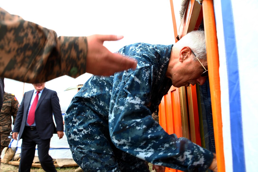 Admiral Samuel Locklear, commander of U.S. Pacific Command, ducks into a ger (traditional Mongolian hut) at Five Hills Training Area following the Khaan Quest 2013 opening ceremony, Aug. 3. Approximately 1,000 service members from 13 different nations are participating in Khaan Quest 2013, which consists of a command post exercise and field training exercise at Five Hills Training Area, both focusing on peacekeeping and stability operations. Mongolian and U.S. armed forces, along with other regional partners, will also participate in Engineering Civic Action Program (ENCAP) projects, as well as Cooperative Health Engagement (CHE) events in Ulaanbaatar, enhancing joint Mongolian-U.S. medical and engineering capabilities and providing outreach to underserved communities.