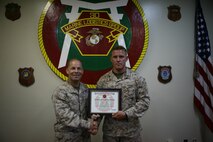 Sgt. Justin L. Kloppe, right, receives a certificate of completion for the Global Combat Support System-Marine Corps Journeymen Program from Col. Mark M. Walter August 1 at the 3rd Marine Logistics Group Headquarters Building on Camp Kinser.  GCSS-MC is a combat-support system that logistically integrates maintenance and supply into one combined system to allow commanders to maintain real-time accountability of all equipment and vehicles across their forces. The Journeyman Program is a 3rd MLG effort to increase GCSS-MC proficiency throughout the logistics group in order to increase III Marine Expeditionary Force Readiness.  Kloppe, from Liberty Hill, Texas, is the first Marine to complete the program.  He spent more than 104 hours in GCSS-MC courses, in addition to six months of managed on-the-job training.  Kloppe is a maintenance management specialist with the GCSS-MC Instructor Program, 3rd MLG, III MEF. Walter is the chief of staff of 3rd MLG.  