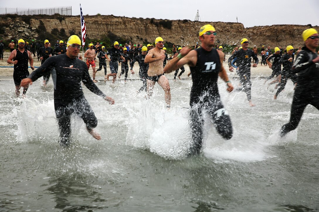 Hundreds of service members and civilians came together on the Assault Craft Unit-5 training beach to participate in the first duathlon and triathlon combination as a part of the Hard Corps Race Series here Aug. 3.
