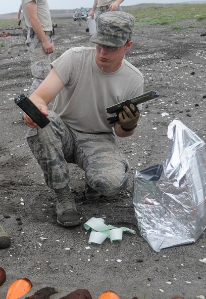 Airman 1st Class Brent Points, 35th Civil Engineer Squadron Explosive Ordnance Disposal apprentice, sets C4 on unexploded ordnance at Draughn Range, near Misawa Air Base, Japan, July 11, 2013. EOD’s job is to neutralize things like Improvised Explosive Devices, Bomb Dummy Units and other explosive hazards to protect personnel and property. (U.S. Air Force photo by Airman 1st Class Kaleb Snay)
