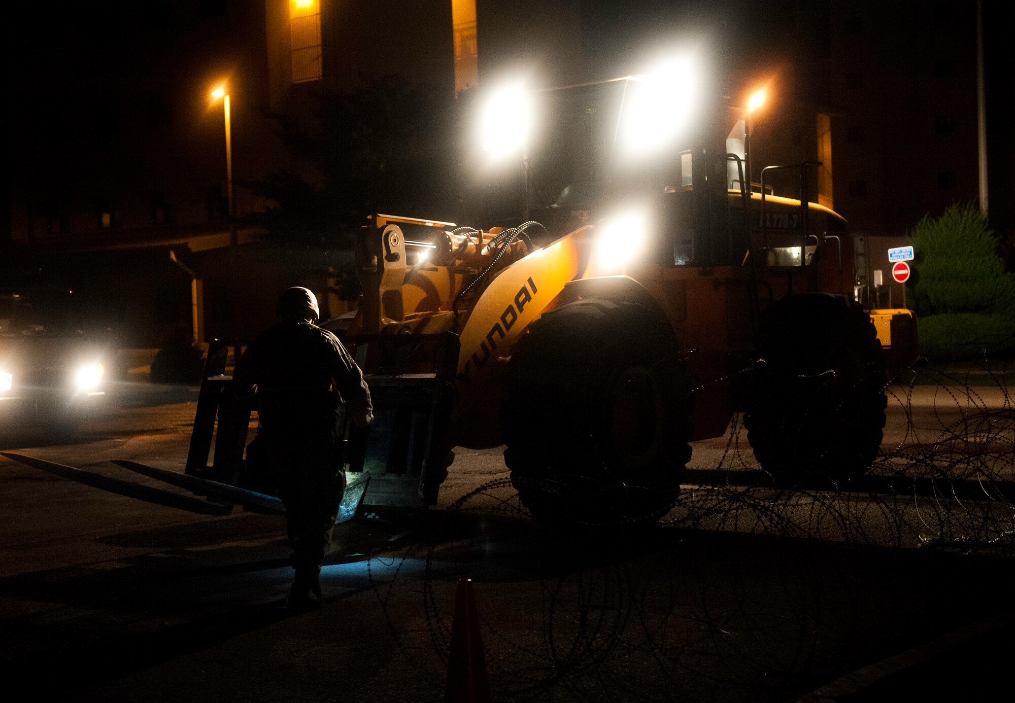 Staff Sgt. Maxwell Evans, 8th Civil Engineer Squadron pavement and heavy equipment technician, clears debris from a fork lift during exercise Beverly Midnight 13-3 at Kunsan Air Base, Republic of Korea, Aug. 5, 2013. The exercise allows Airmen to operate under increased security measures for prolonged periods of time. (U.S. Air Force photo by Senior Airman Clayton Lenhardt/Released)