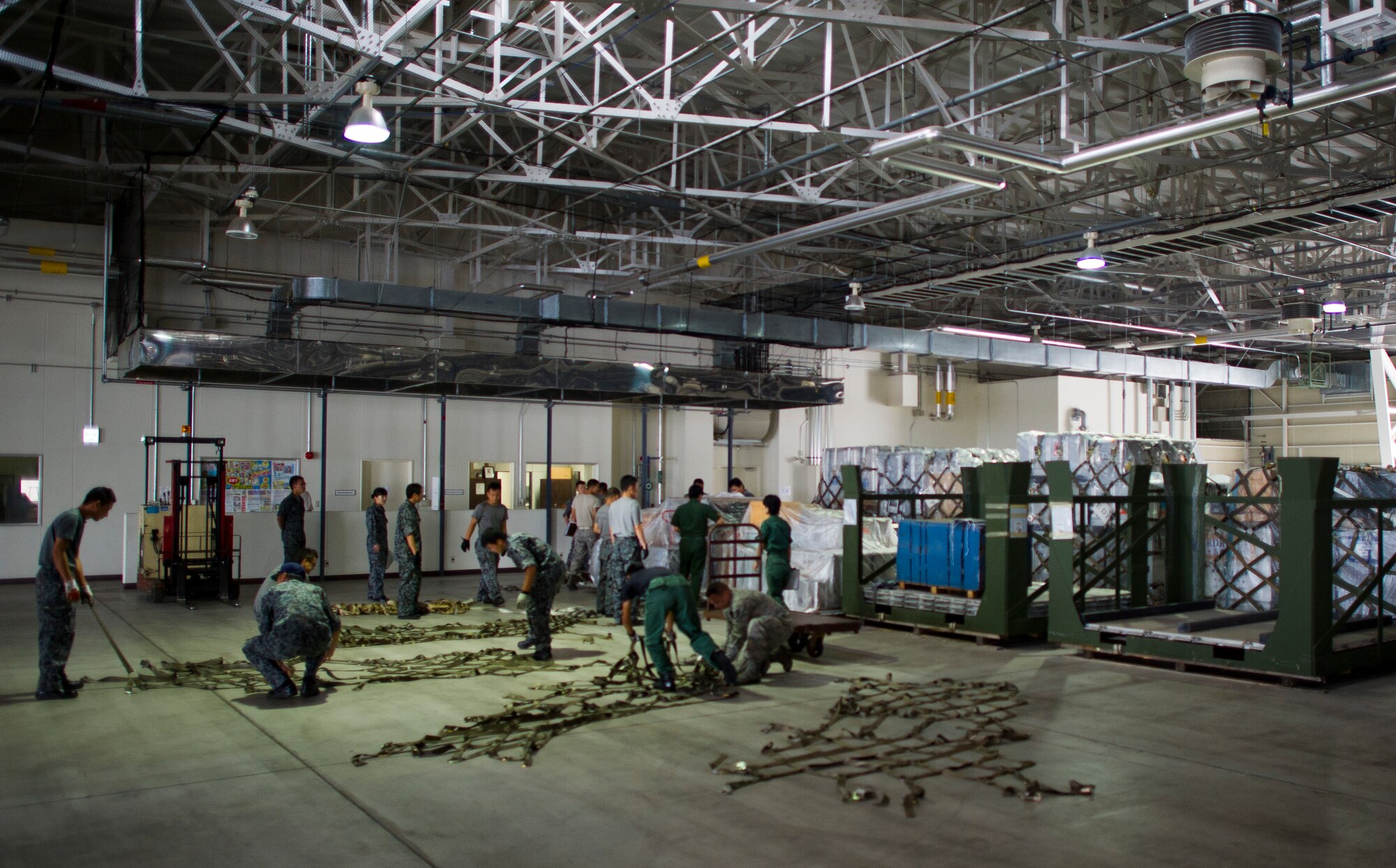 YOKOTA AIR BASE, Japan -- Members from the 730th Air Mobility Squadron and the Japan Air Self-Defense Force prepare and inspect several pallets heading to Alaska in support of Red Flag-Alaska at Yokota Air Base, Japan, Aug. 2, 2013. The 730 AMS assisted the Japan Air Self-Defense Force to ensure all Japanese cargo was properly inspected and prepared for loading. (U.S. Air Force photo by Staff Sgt. Chad C. Strohmeyer)