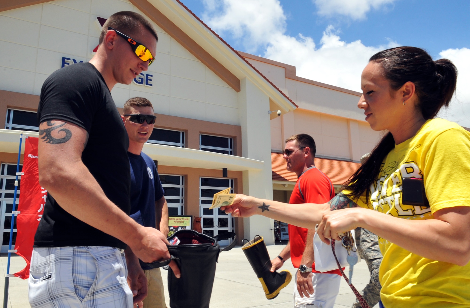 Futenma’s Aircraft Rescue Fire Department and Kadena’s Fire Department help raise donations for the Kadena Special Olympics during the Fill the Boot campaign on Kadena Air Base, Japan, Aug. 2, 2013. This year’s campaign marks the 14th year and more than $27,120 was raised for last year’s KSO. (U.S. Air Force photo by Naoto Anazawa/Released)