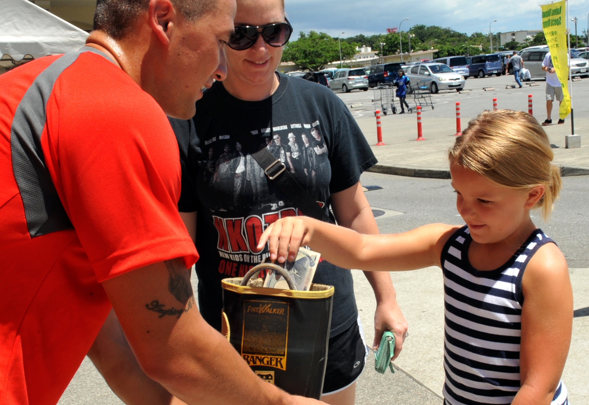 People of all ages donate money for the Kadena Special Olympics during the Fill the Boot campaign on Kadena Air Base, Japan, Aug. 2, 2013. This campaign continued until Aug. 4 at the Commissary, Exchange and shoppettes on Kadena. (U.S. Air Force photo by Naoto Anazawa/Released)