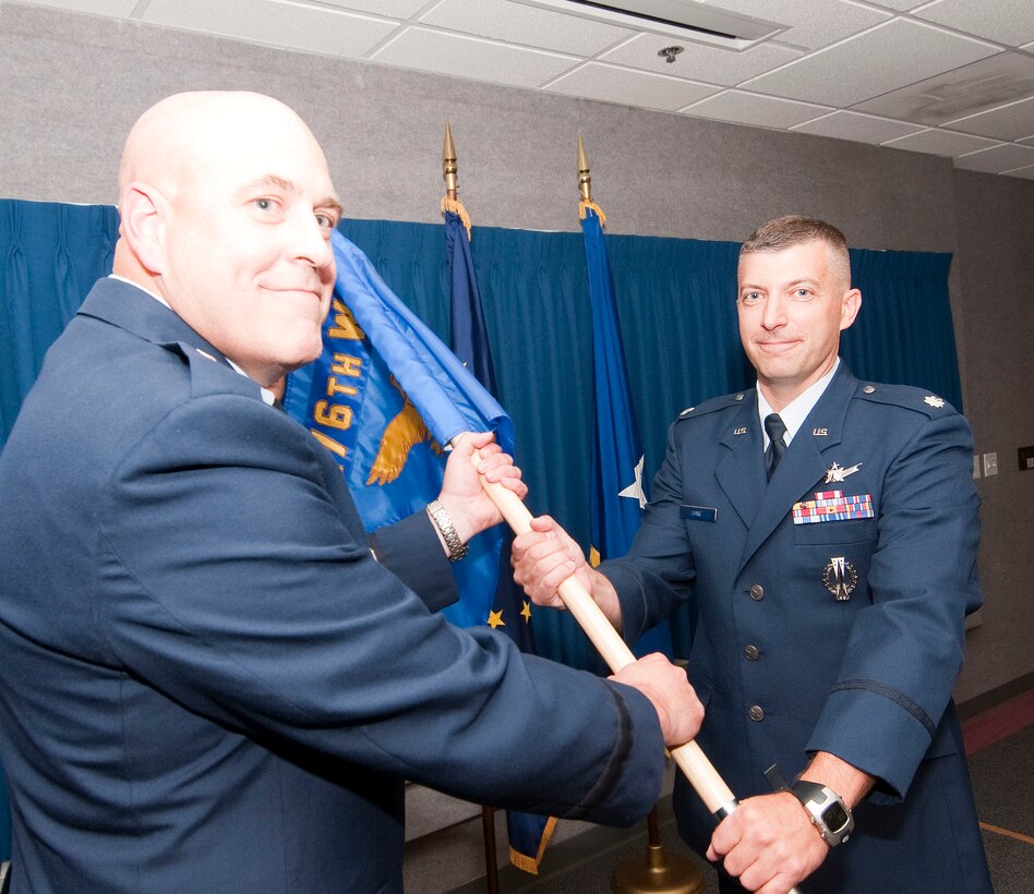 Lt. Col. Tory Saxe (right) receives the 176th Maintenance Group command flag from the 176th Wing commander, Brig. Gen. Donald S. Wenke, at an Aug. 3, 2013 assumption-of-command ceremony at Joint Base Elmendorf-Richardon, Alaska. National Guard photo by Capt. John Callahan.