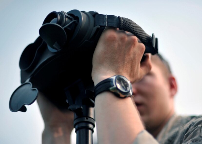 Airman 1st Class Nick Hurren, 604th Air Support Operations Squadron joint terminal attack controller, looks through a set of rangefinders during live close air support training at Rodriguez Range, Republic of Korea, June 27, 2013. Because of the impact they can have on any battlefield, JTACs maintain a rigorous training schedule in which they utilize the many tools of their trade. (U.S. Air Force photo/Senior Airman Siuta B. Ika)