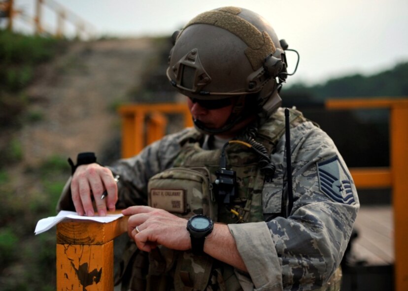 Master Sgt. Robert Callaway, outgoing operations superintendent of the 604th Air Support Operations Squadron, writes down coordinates during live close air support training at Rodriguez Range, Republic of Korea, June 27, 2013. JTACs control attacks from aircraft and artillery while keeping non-combatants and friendly forces safe. (U.S. Air Force photo/Senior Airman Siuta B. Ika)