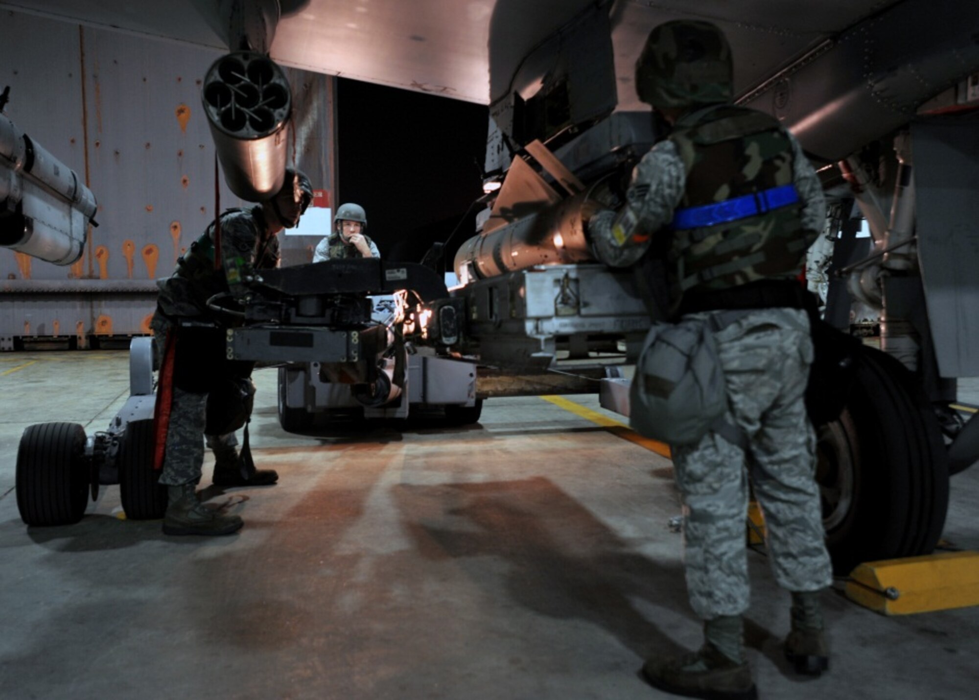 Weapons loaders from the 51st Aircraft Maintenance Squadron place a bomb on an A-10 Thunderbolt during the start of Beverly Midnight 13-03 at Osan Air Base, Republic of Korea, August 5, 2013. Airmen will perform 24-hour operations during the week-long exercise. (U.S. Air Force photo/Senior Airman Siuta B. Ika)