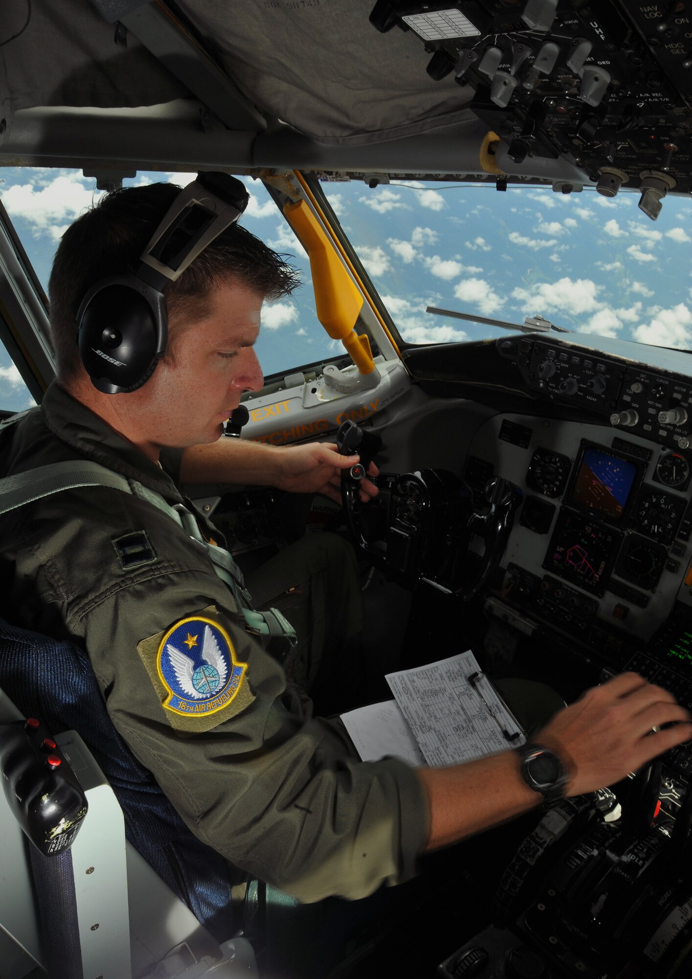 Capt. Jason Helmick, a pilot assigned to the Air Force Reserve 18th Air Refueling Squadron, 931st Air Refueling Group, McConnell Air Force Base Kan., checks the cockpit console of a KC-135 Stratotanker while practicing tactical maneuvers over Arkansas, Aug. 3, 2013. Training missions with aerial refueling and tactical maneuvering allow pilots to extend the radius of other aircraft, enabling precision missions around the globe 24 hours a day. (U.S. Air Force photo by Staff Sgt. Jess Lockoski)