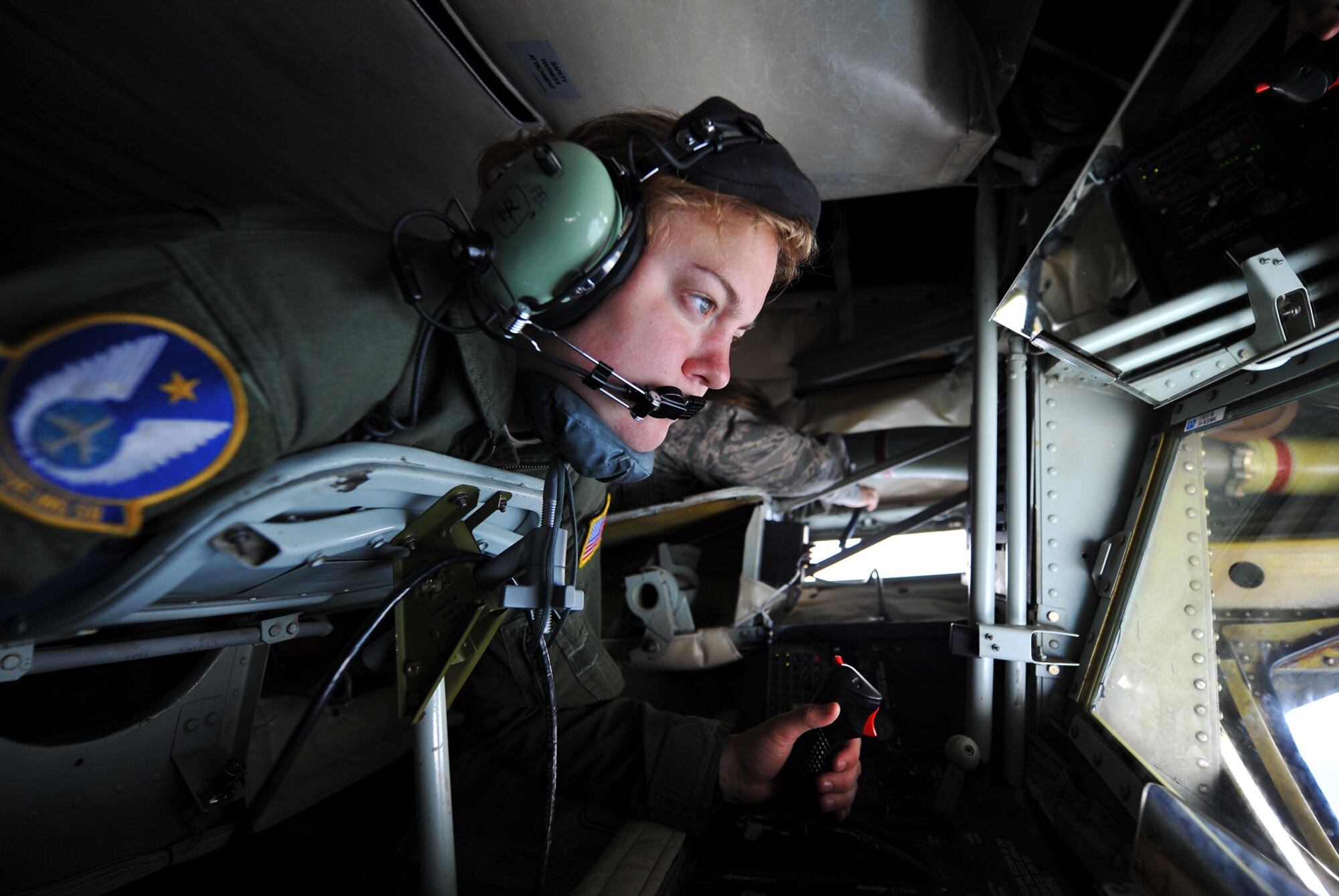 Senior Airman Sierra Dopfel,  a refueling boom operator assigned to the Air Force Reserve 18th Air Refueling Squadron, 931st Air Refueling Group, McConnell Air Force Base Kan., peers out of the boom pod of a KC-135 Stratotanker during an air refueling training mission, Aug. 3, 2013. The KC-135 was refueling a B-52 Stratofortress assigned to the 307th Bomb Wing Barkesdale AFB, La., Air Refueling training missions ensure that both the refueling and receiving aircrews maintain proficiency in air refueling operations, allowing the Air Force to extend its reach around the globe. (U.S. Air Force photo by Staff Sgt. Jess Lockoski)