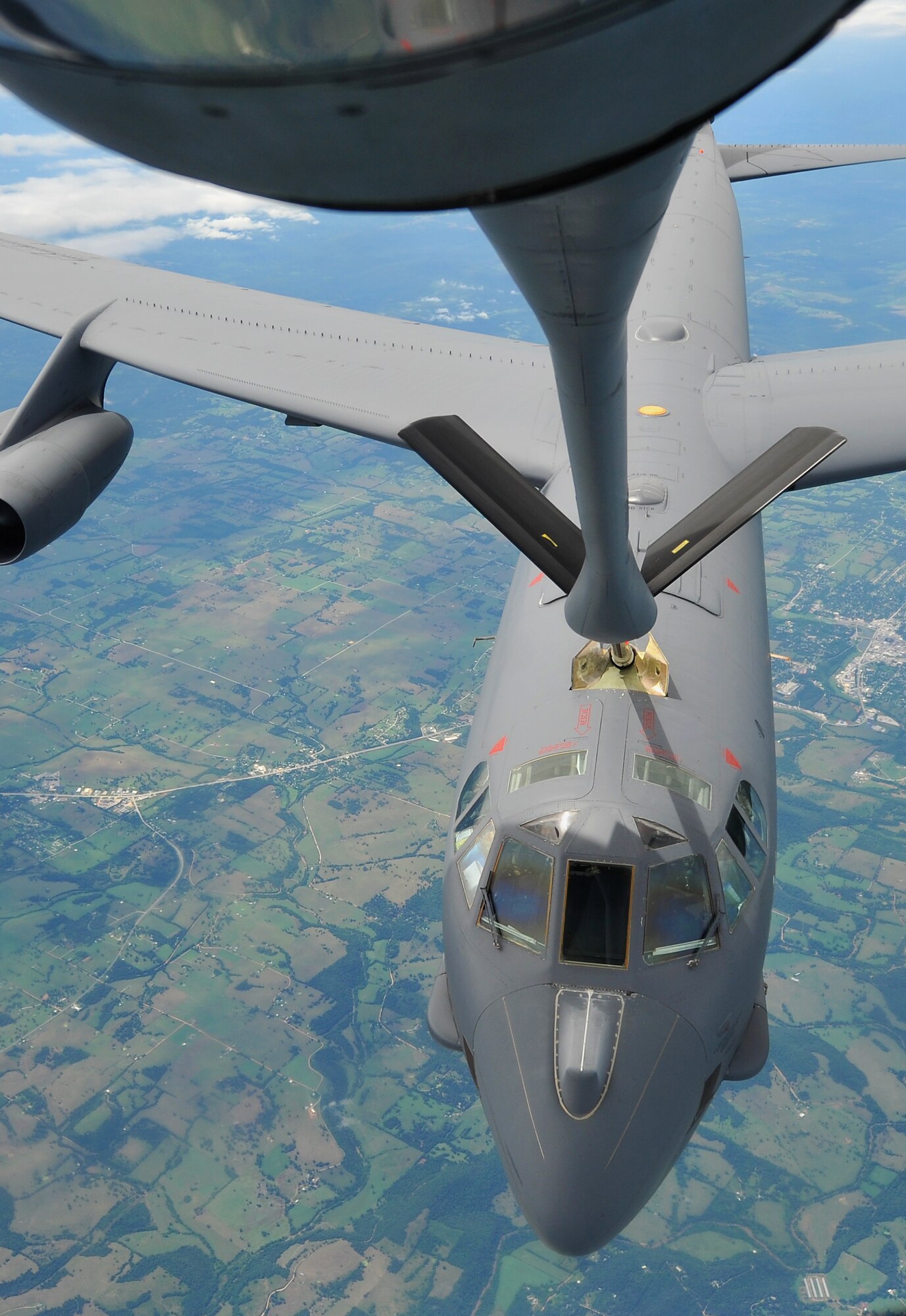 A B-52 Stratofortress from the 307th Bomb Wing, Barksdale Air Force Base, La., is positioned to take fuel from a KC-135 Stratotanker flown by the 18th Air Refueling Squadron, Air Force Reserve Command, McConnell AFB, Kan., Aug. 3, 2013, over Arkansas. Air refueling training keep 18 ARS members proficient in all essential aspects of air refueling operations.   (U.S. Air Force photo by Staff Sgt. Jess Lockoski)