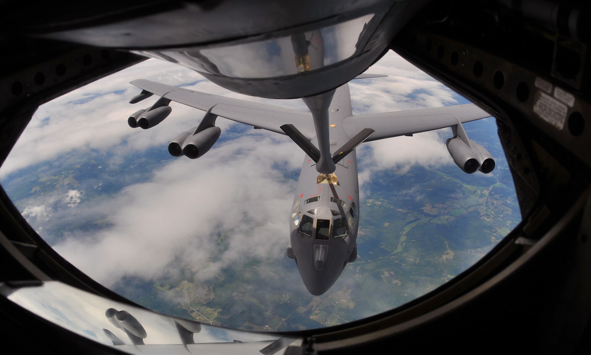 A B-52 Stratofortress from the 307th Bomb Wing, Barksdale Air Force Base, La., is positioned to take fuel from a KC-135 Stratotanker flown by the 18th Air Refueling Squadron, Air Force Reserve Command, McConnell AFB, Kan., Aug. 3, 2013, over Arkansas. Air refueling training keep 18 ARS members proficient in all essential aspects of air refueling operations.   (U.S. Air Force photo by Staff Sgt. Jess Lockoski)