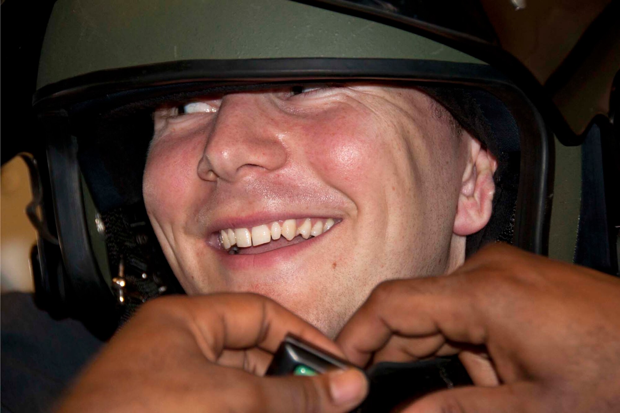 U.S. Air Force Chaplain Candidate 2nd Lt.Vincent Gillmore is all smiles as a member of the 2nd Bomb Wing explosive ordinance disposal unit fits him with a protective helmet at Barksdale Air Force Base, La., Aug. 2, 2013.  EOD members let the chaplain candidates try on the helmet and 90 pound protective suit that goes with it.  Such experiences help the candidates have greater understanding of the stressors and strains faced by EOD members.  Beyond the physical hardships, the EOD members also face mental stress in their dangerous occupation.  Gaining insight into these issues and others facing EOD members was the reason the candidates visited the unit. (U.S. Air Force photo by Tech. Sgt. Ted Daigle/Released)