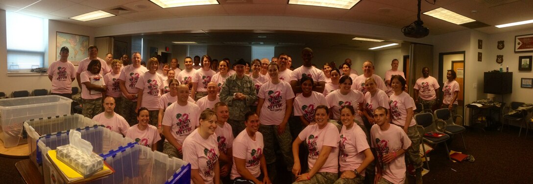 Members of the 914th Aeromedical Staging Squadron don pink shirts to show support for fellow Airman, Master Sgt. Anne Davis, 914th ASTS. Master Sgt. Davis was diagnosed with breast cancer earlier this year and is currently undergoing chemotherapy. (courtesy photo) 