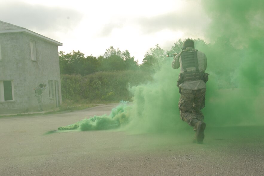 An Airman with the 178th Security Forces Squadron, Ohio Air National Guard portrays an opposing force aggressor during military operations in urban terrain training July 31, 2013 at Combat Readiness Training Center Alpena, Mich. Members of the 178th participated in the military operations in urban terrain training during the annual Alpena Michigan training exercise. (U.S. Air National Guard photo by Master Sgt. Seth Skidmore/Released)