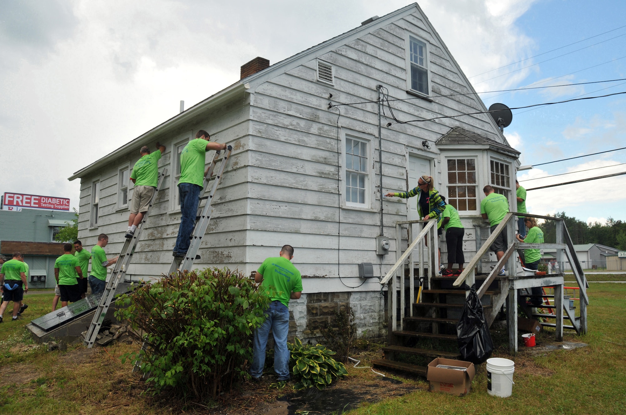 Members of the 178th Fighter Wing contribute to the beatification of a home Aug 1, 2013 in support of Habitat for Humanity while training at the Combat Readiness Training Center, Alpena, Mich. Airmen of the 178th Fighter Wing deployed to the Alpena CRTC as part of a team building and training exercise to fulfill their annual training requirements. (U.S. Air National Guard photo by Tech. Sgt. Antonio Vega/Released)