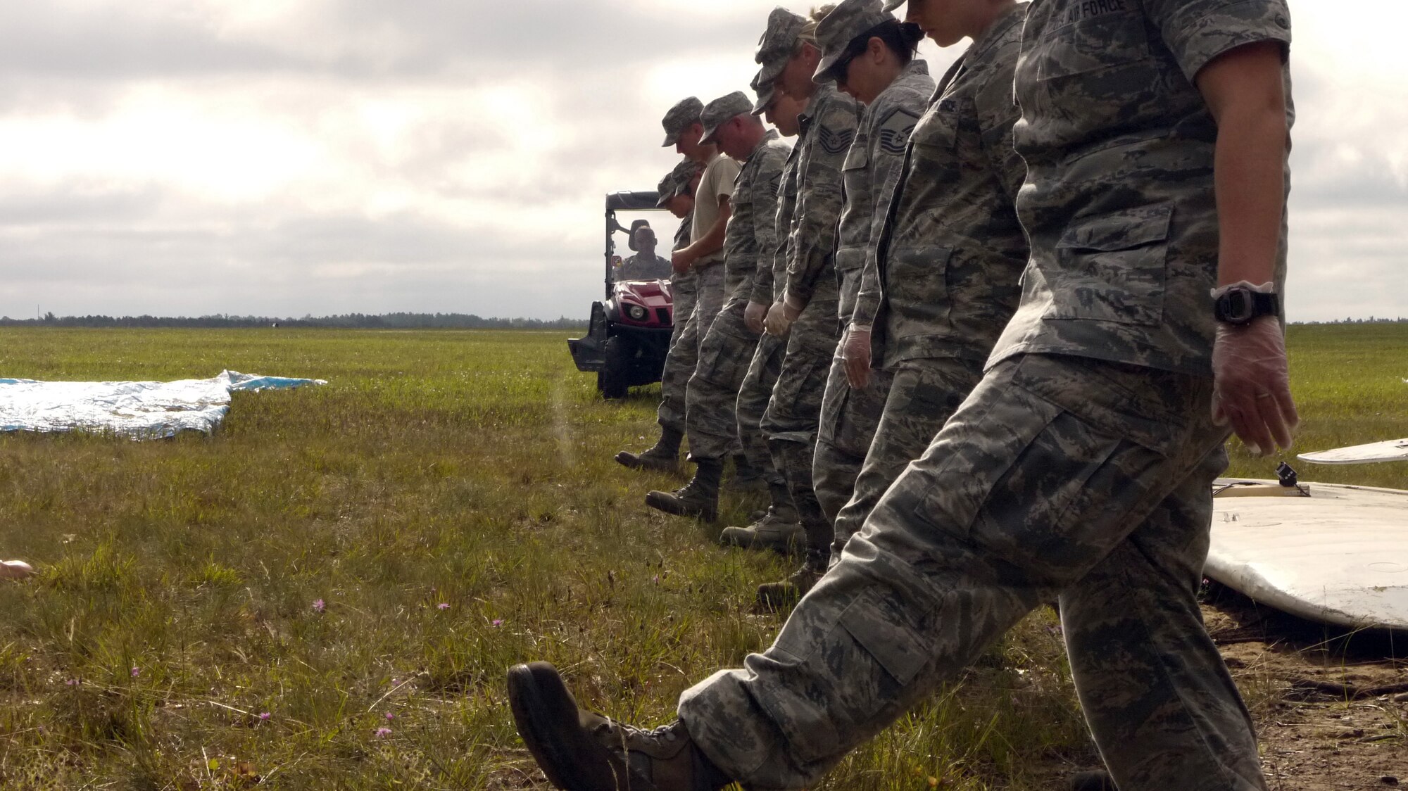 Services and Personnel members from the 178th Force Support Squadron step off during part of a search and recovery exercise held Aug. 1 at the Combat Readiness Training Center, Alpena, Mich.  The services and personnel components of FSS have real-world requirements regarding situations that would require search and recovery, mortuary affairs and notification.  The exercise scenario involved a plane crash with two deceased individuals.  (U.S. Air National Guard photo by Maj. Lindsay Logsdon/Released)